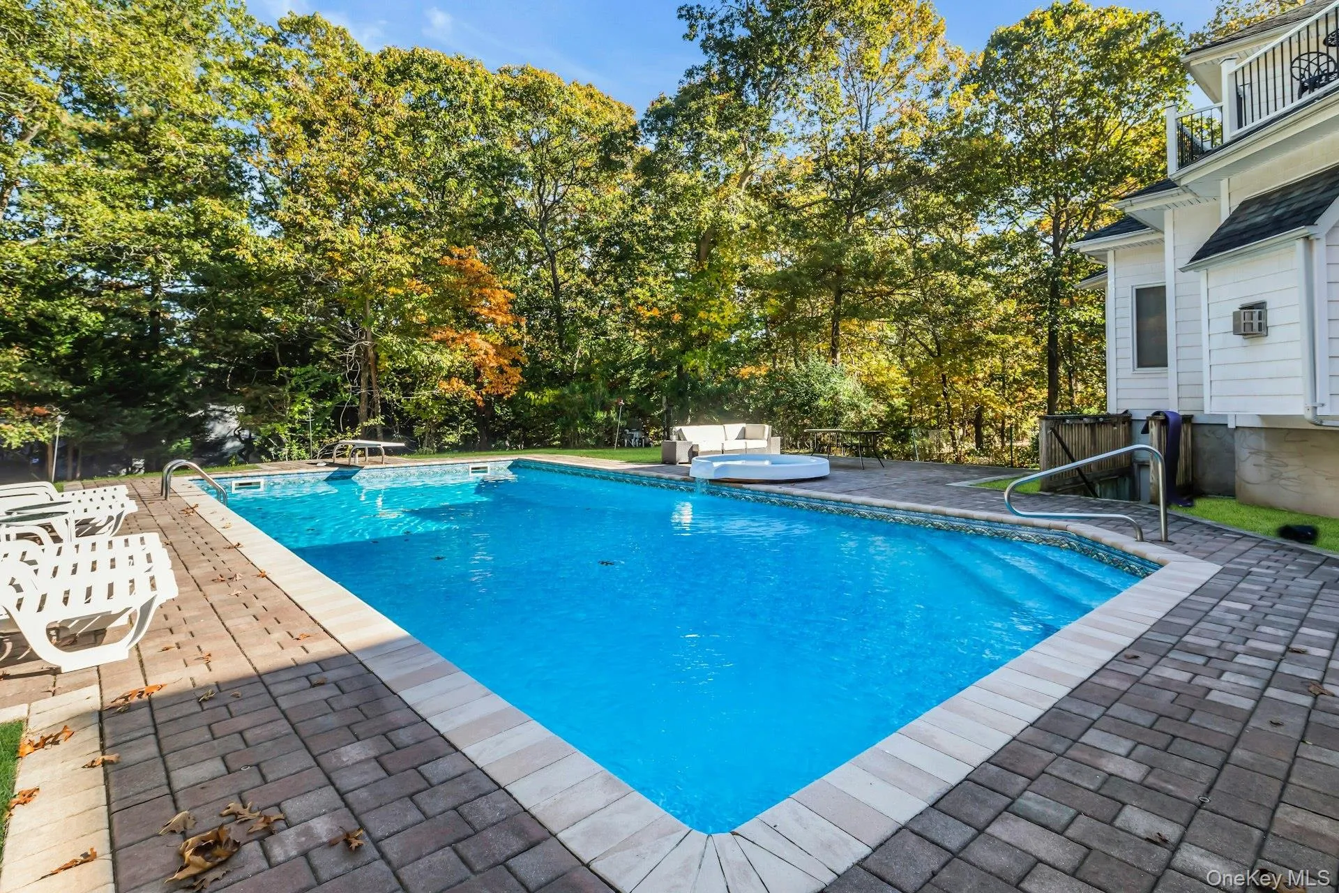 View of pool with a patio and a diving board
