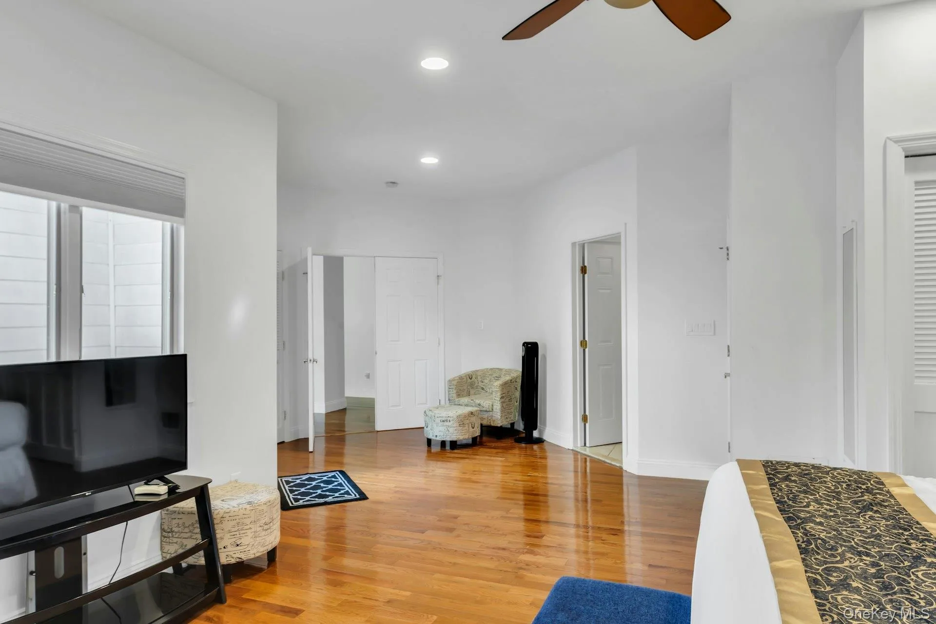 Living area featuring light wood finished floors, recessed lighting, and a ceiling fan