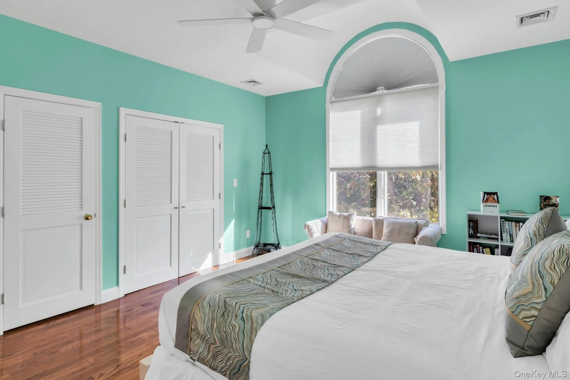 Bedroom featuring dark wood-type flooring and a ceiling fan