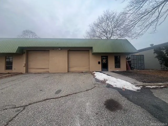 View of front facade featuring asphalt driveway, a metal roof, and an attached garage View of front facade featuring asphalt driveway, a metal roof, and an attached garage