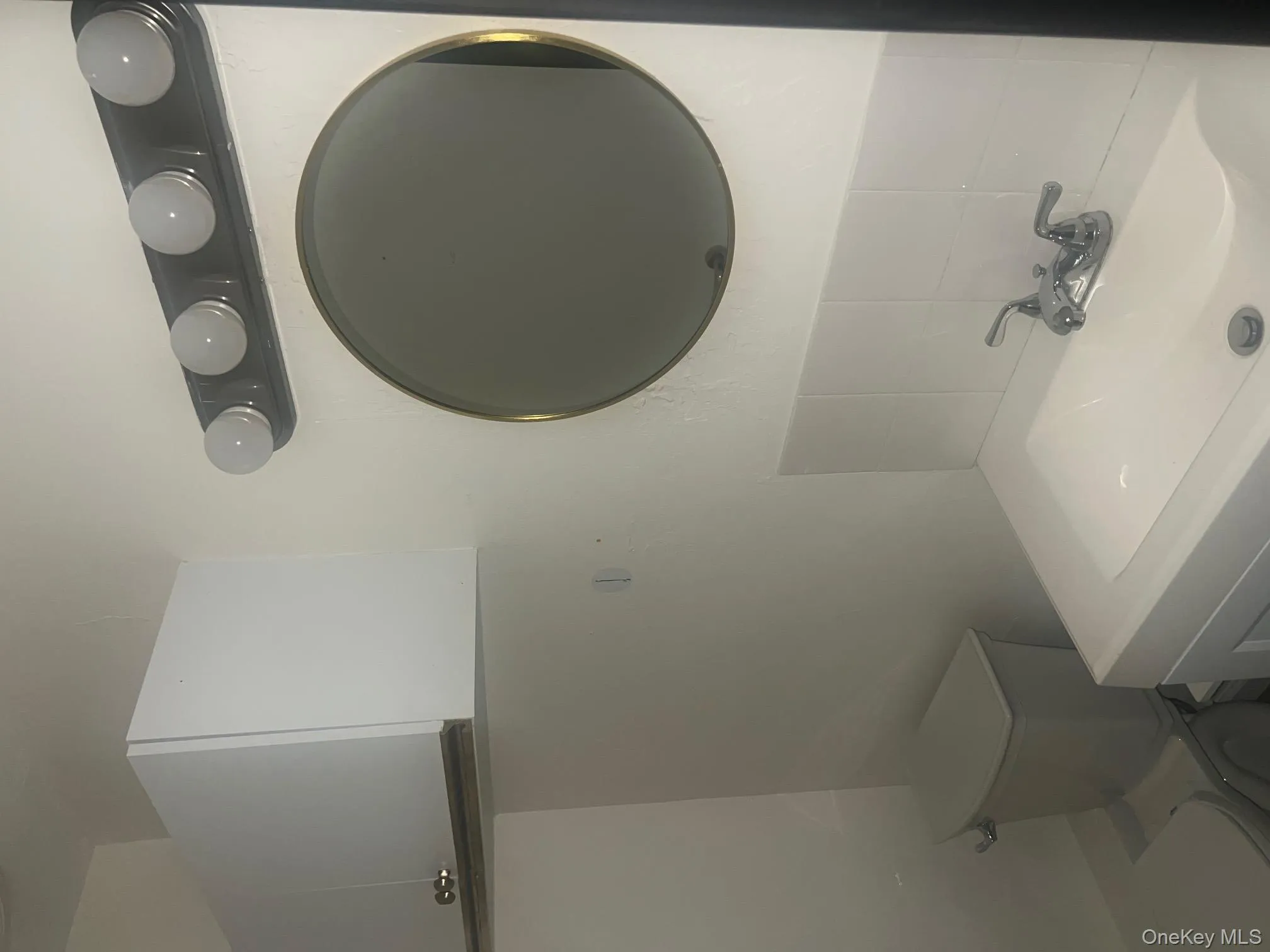 Half bathroom featuring vanity and backsplash Half bathroom featuring vanity and backsplash