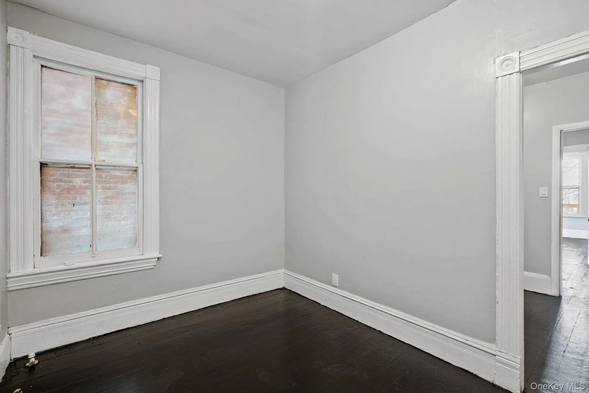 Spare room featuring dark wood finished floors Spare room featuring dark wood finished floors