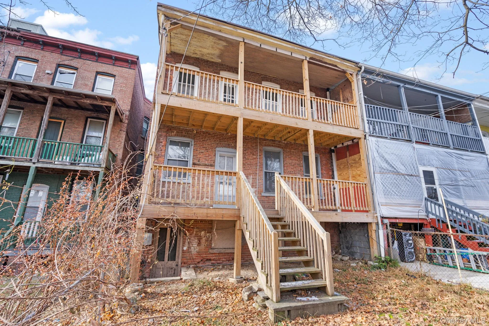 Rear view of house with brick siding and stairway Rear view of house with brick siding and stairway