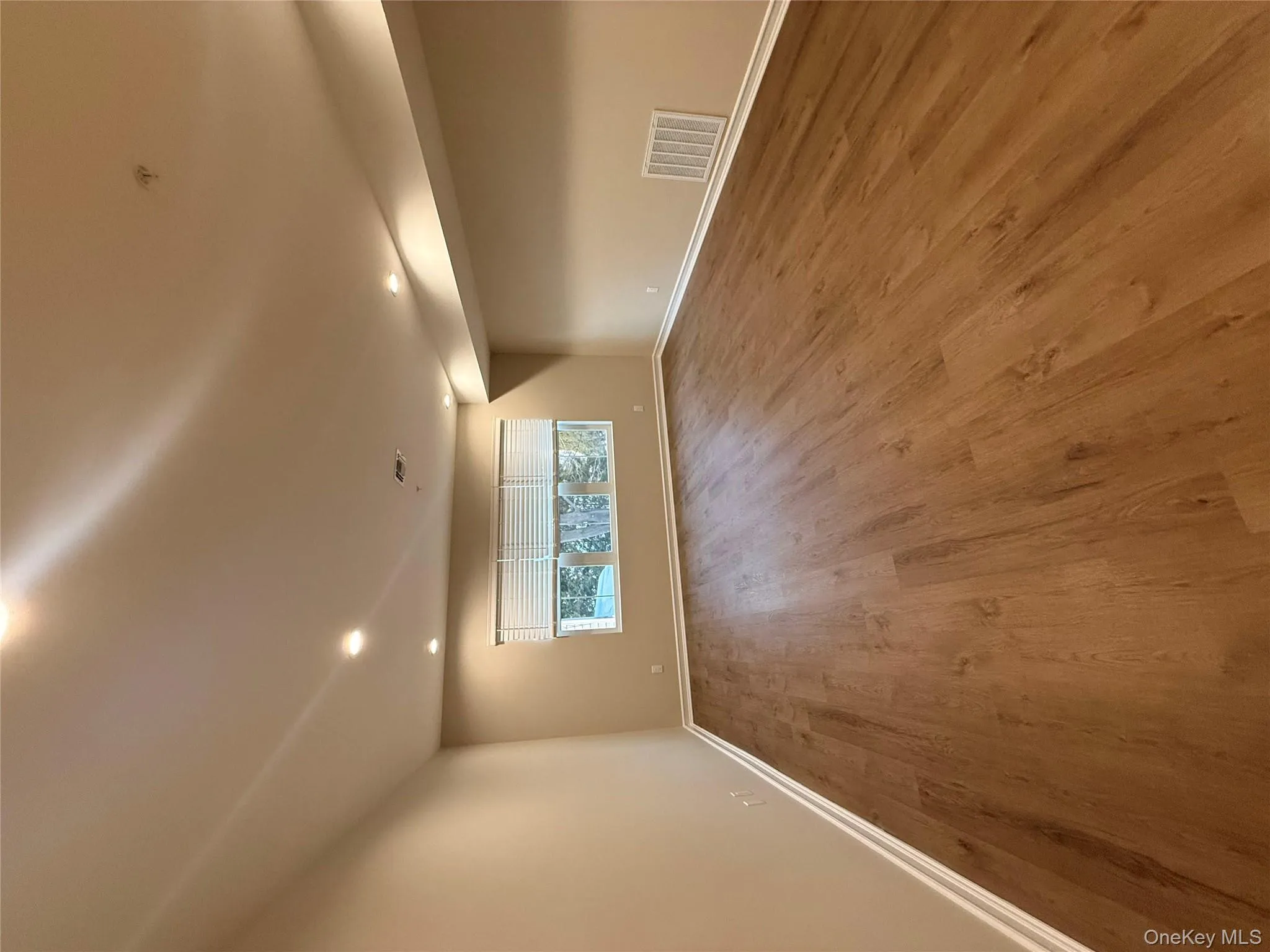 Spare room with wood finished floors and recessed lighting Spare room with wood finished floors and recessed lighting