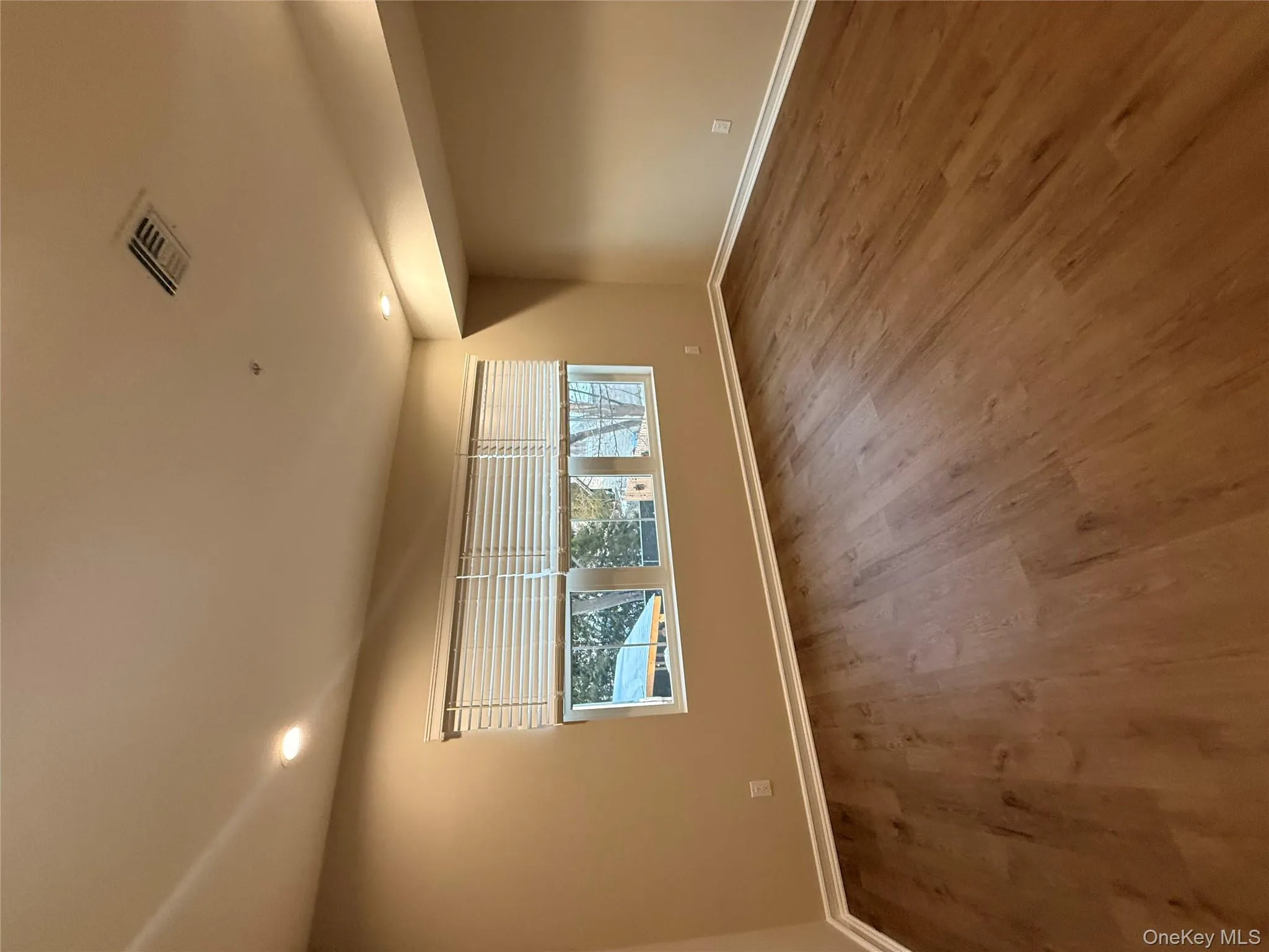 Unfurnished room featuring recessed lighting and dark wood-style floors Unfurnished room featuring recessed lighting and dark wood-style floors