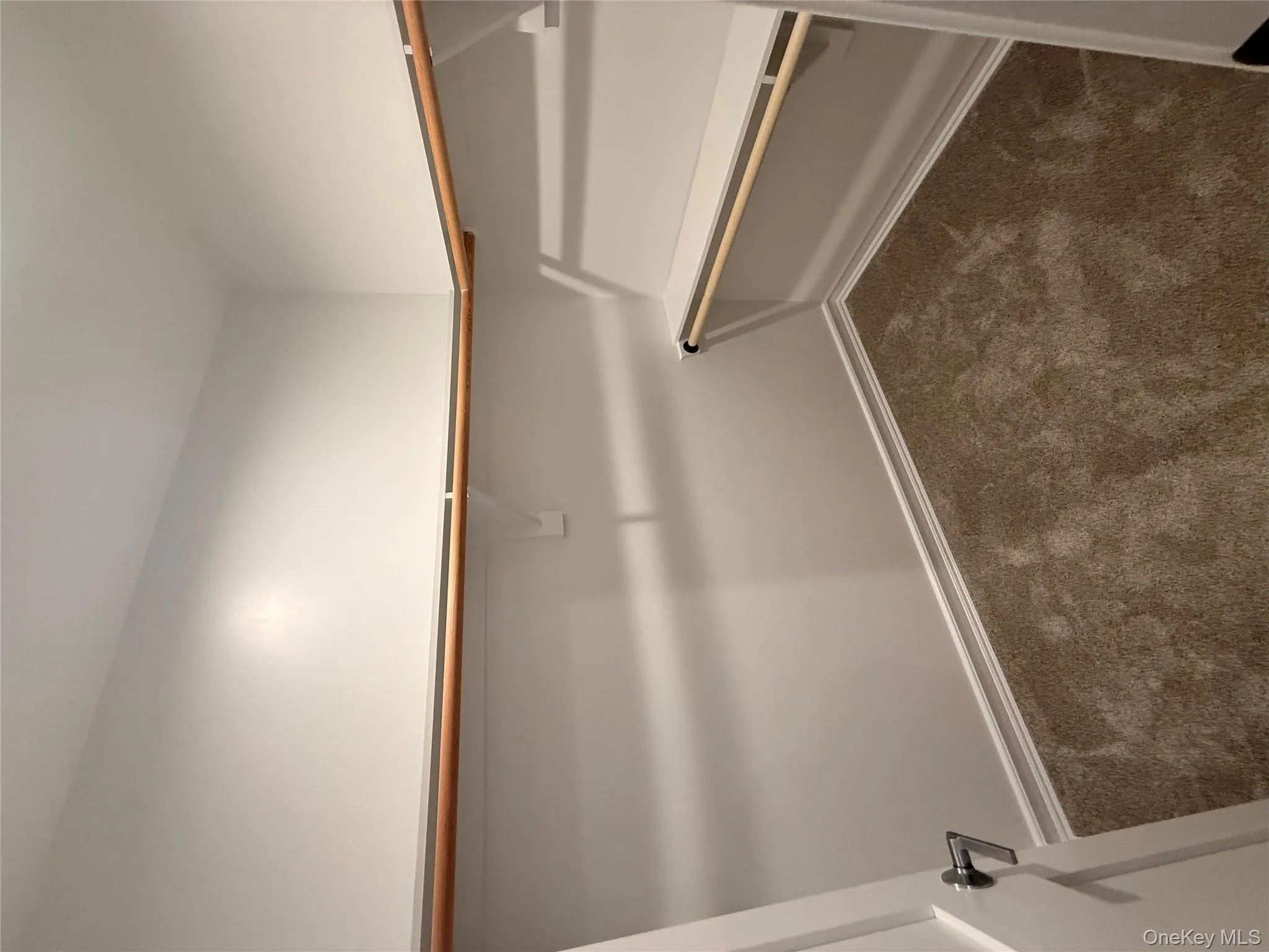 Walk in closet with dark colored carpet Walk in closet with dark colored carpet