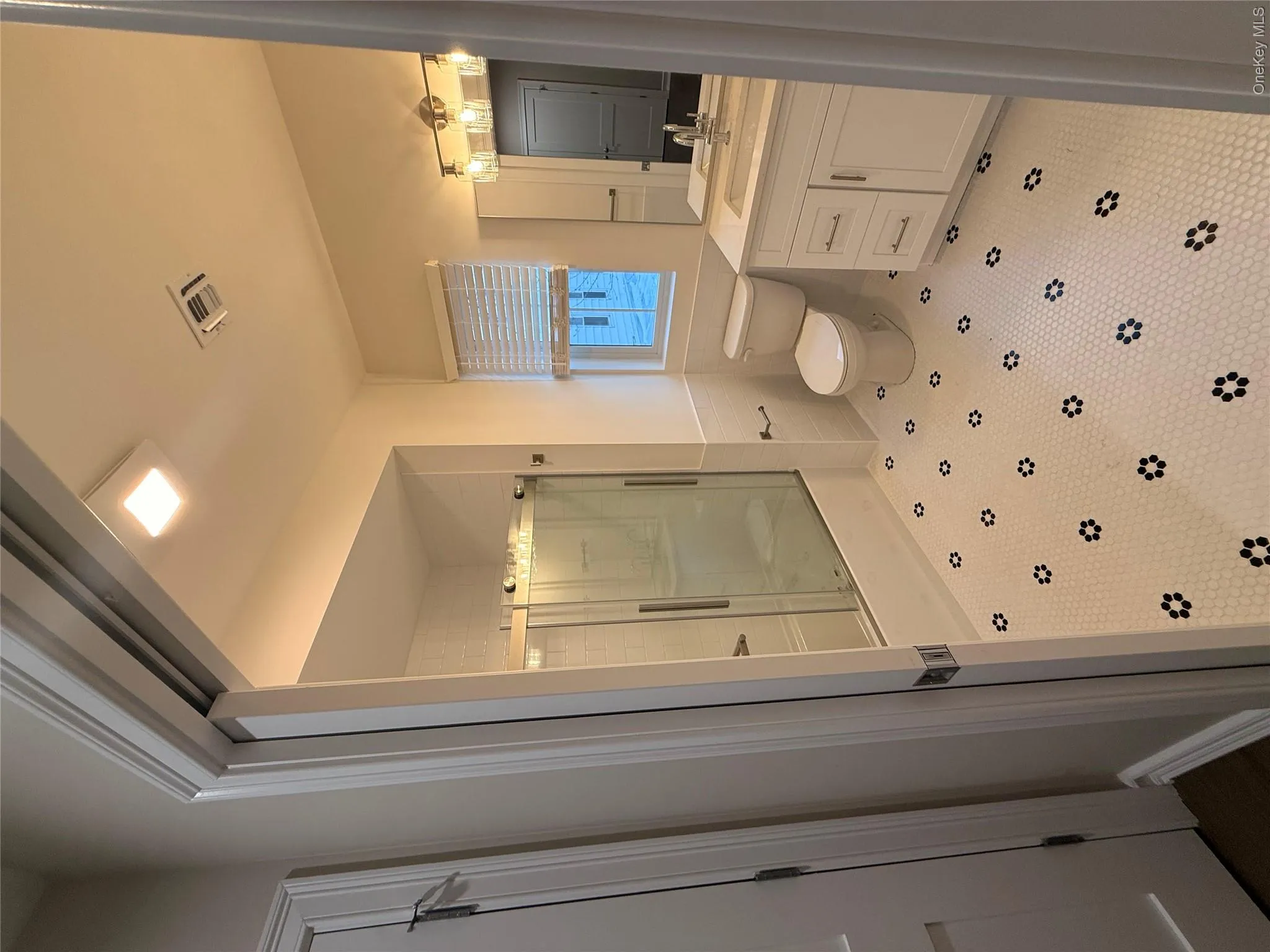 Full bath featuring an enclosed shower and vanity Full bath featuring an enclosed shower and vanity