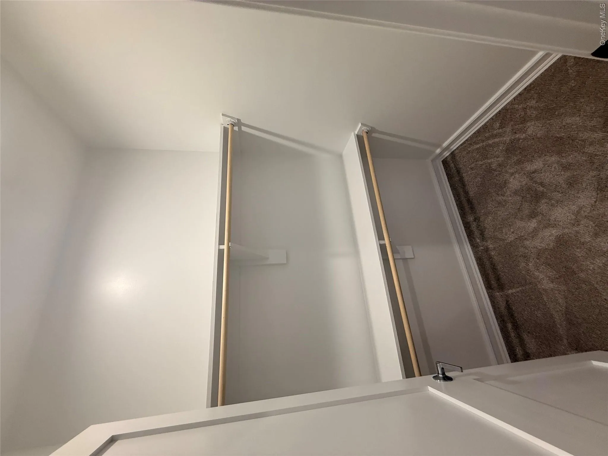 Spacious closet featuring dark colored carpet Spacious closet featuring dark colored carpet