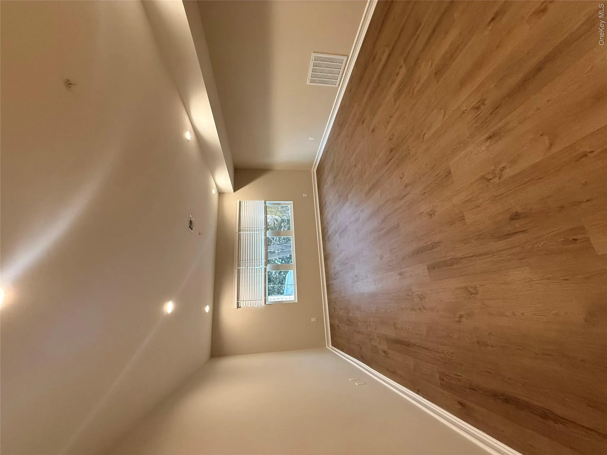 Spare room with wood finished floors and recessed lighting Spare room with wood finished floors and recessed lighting