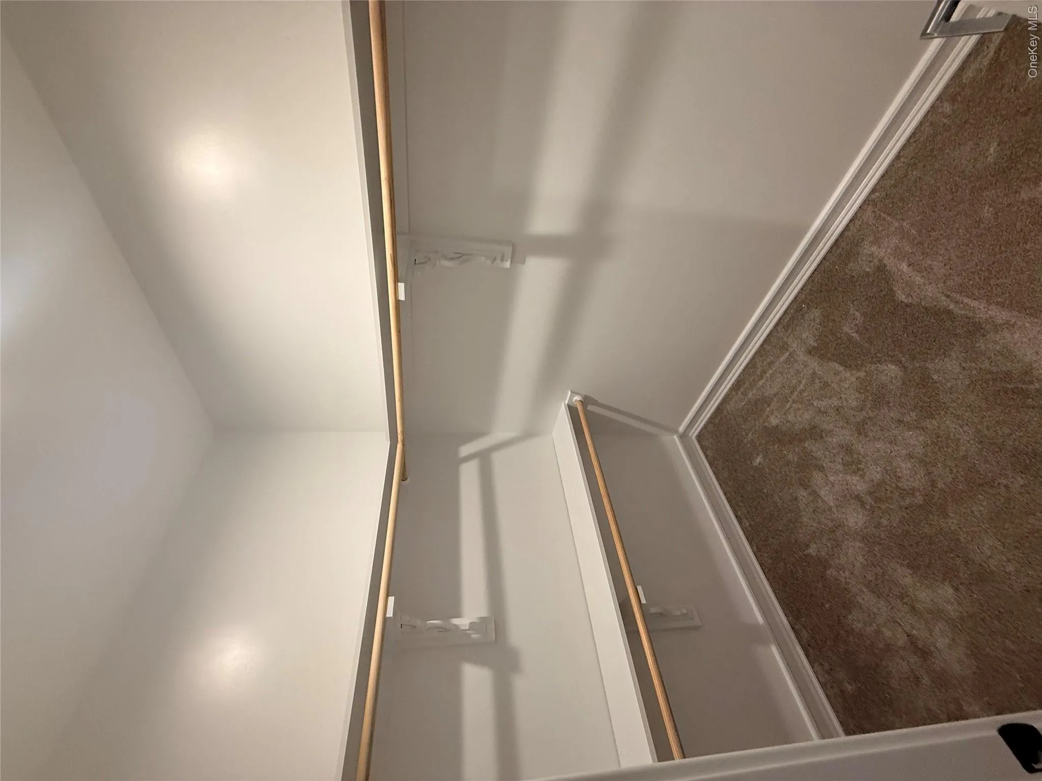 Spacious closet with dark colored carpet Spacious closet with dark colored carpet