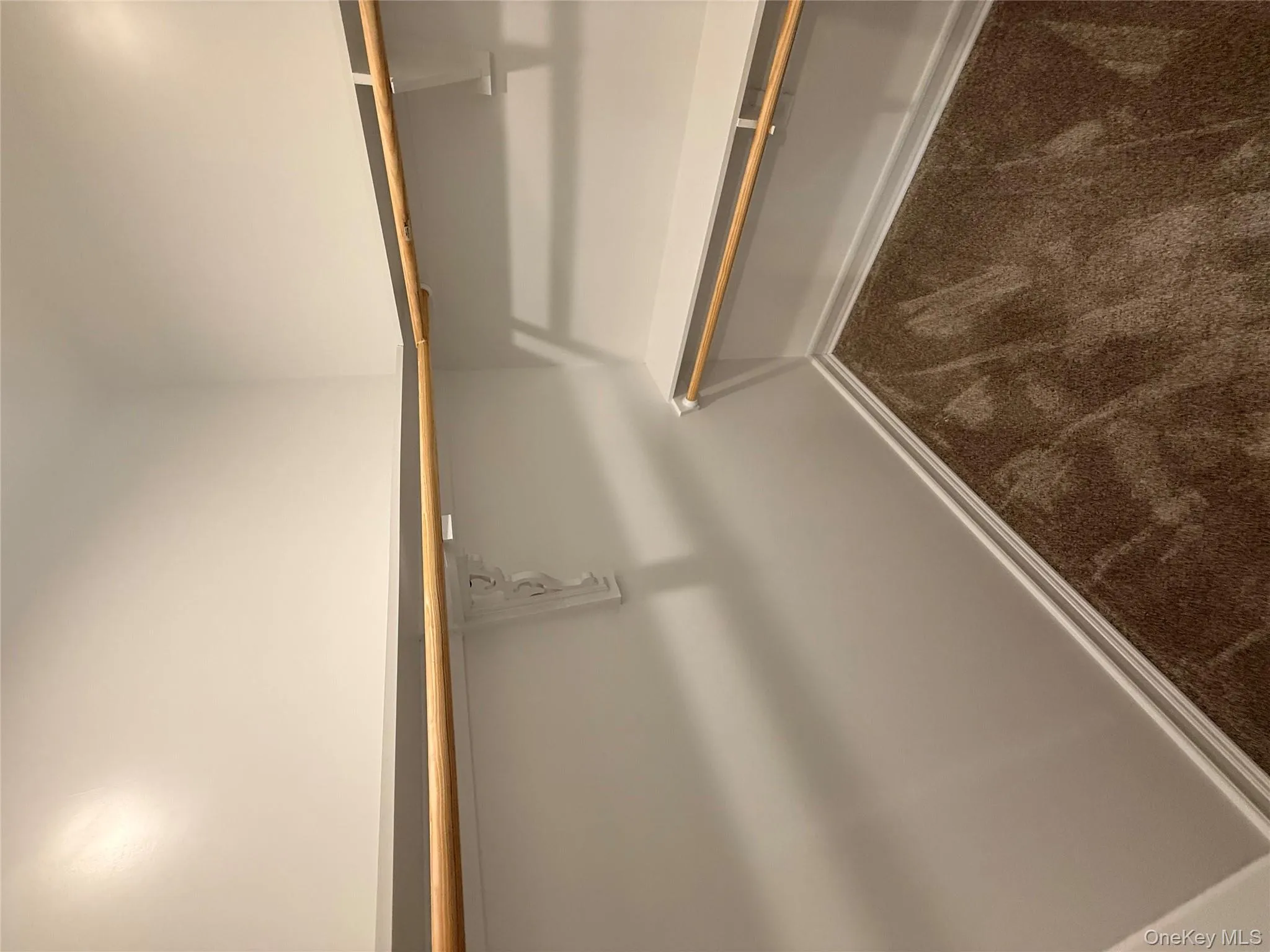 Spacious closet featuring dark colored carpet Spacious closet featuring dark colored carpet