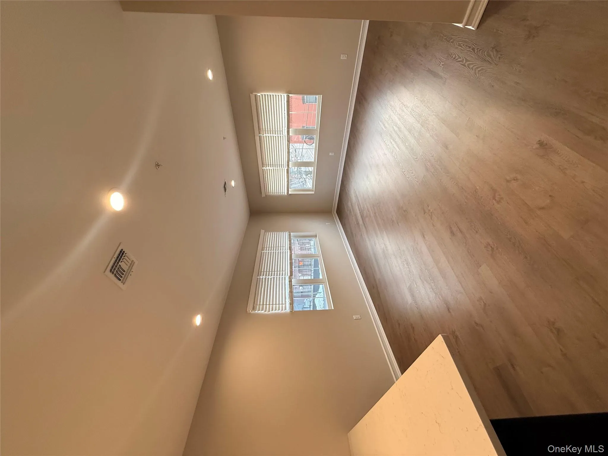 Unfurnished living room with recessed lighting and dark wood-type flooring Unfurnished living room with recessed lighting and dark wood-type flooring