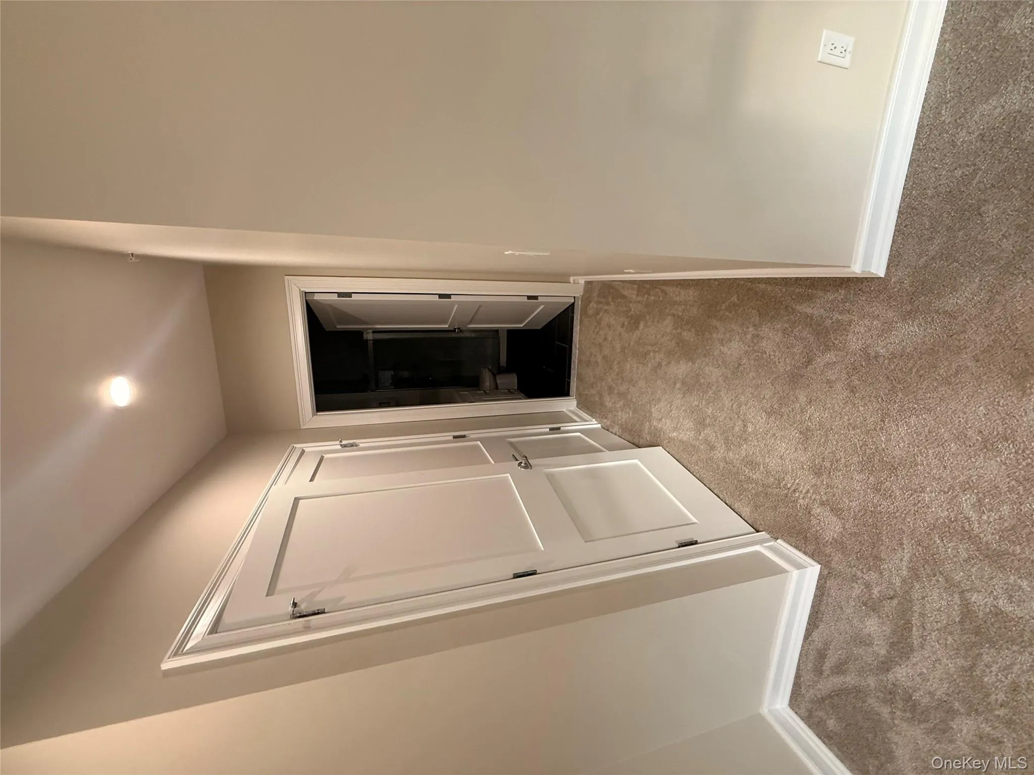 Corridor with carpet flooring and baseboards Corridor with carpet flooring and baseboards