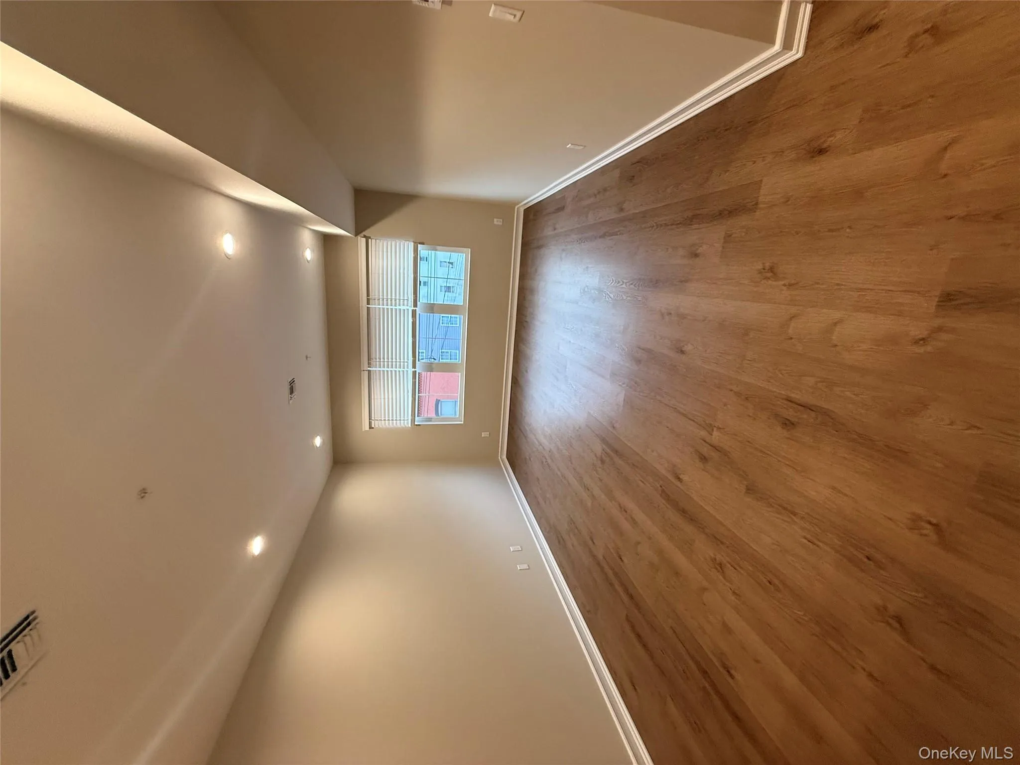 Unfurnished room with wood finished floors and recessed lighting Unfurnished room with wood finished floors and recessed lighting