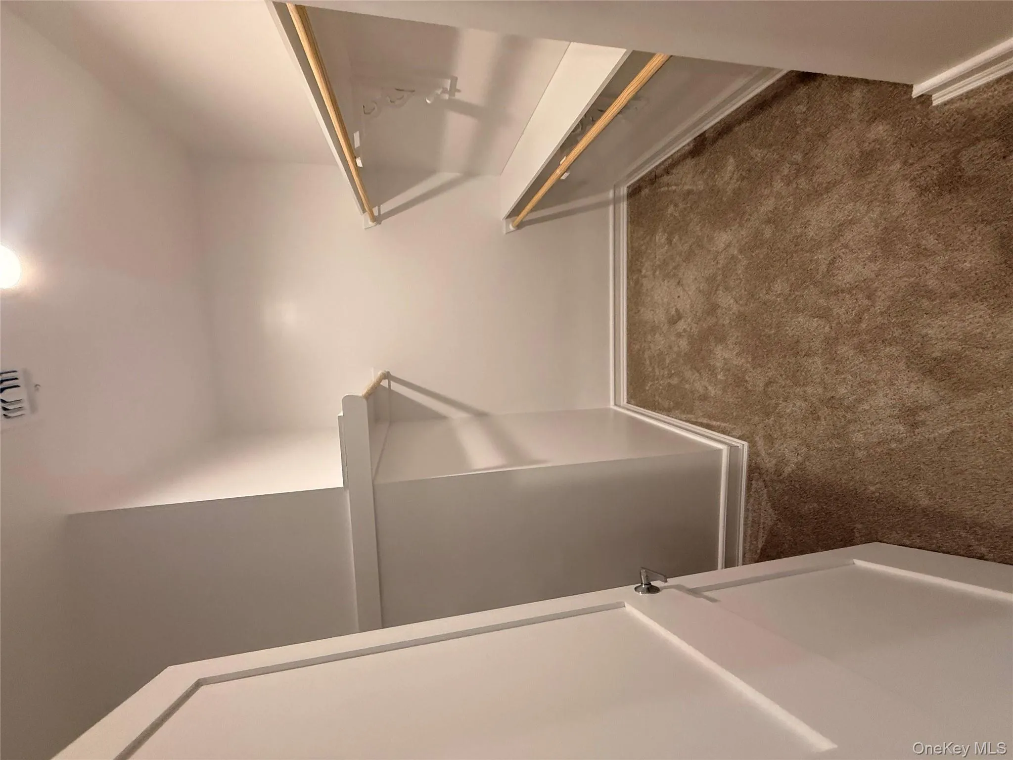 Walk in closet featuring dark carpet Walk in closet featuring dark carpet