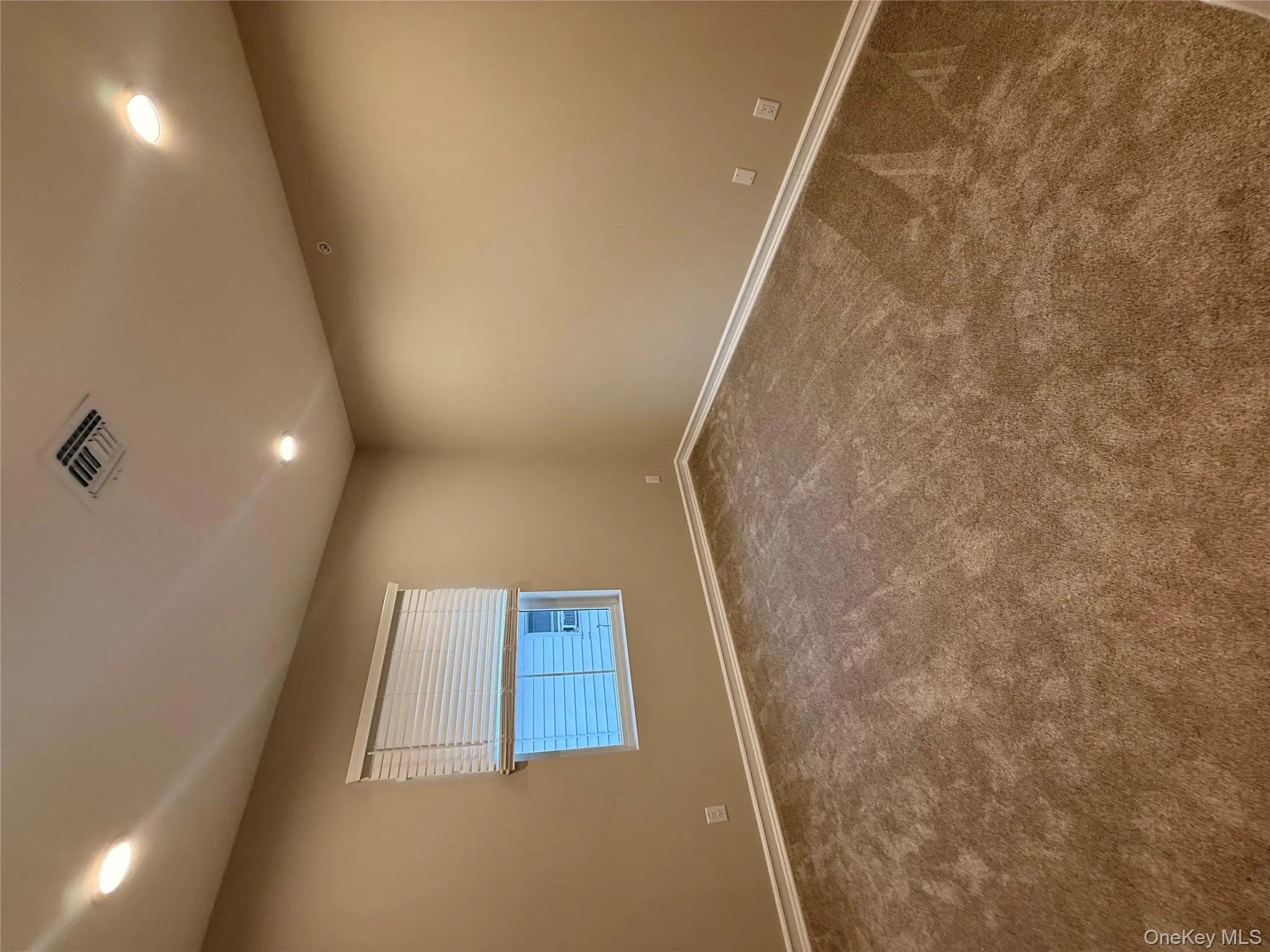 Empty room featuring recessed lighting and dark carpet Empty room featuring recessed lighting and dark carpet