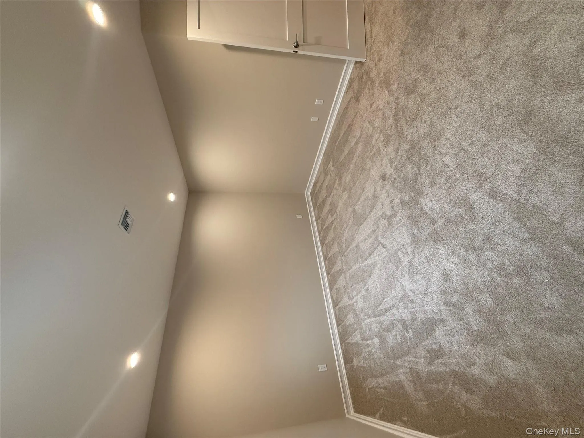 Spare room with light colored carpet and recessed lighting Spare room with light colored carpet and recessed lighting