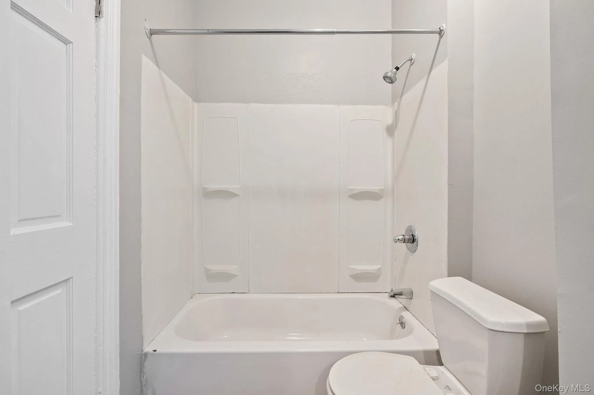 Full bathroom featuring toilet and shower / bathtub combination Full bathroom featuring toilet and shower / bathtub combination