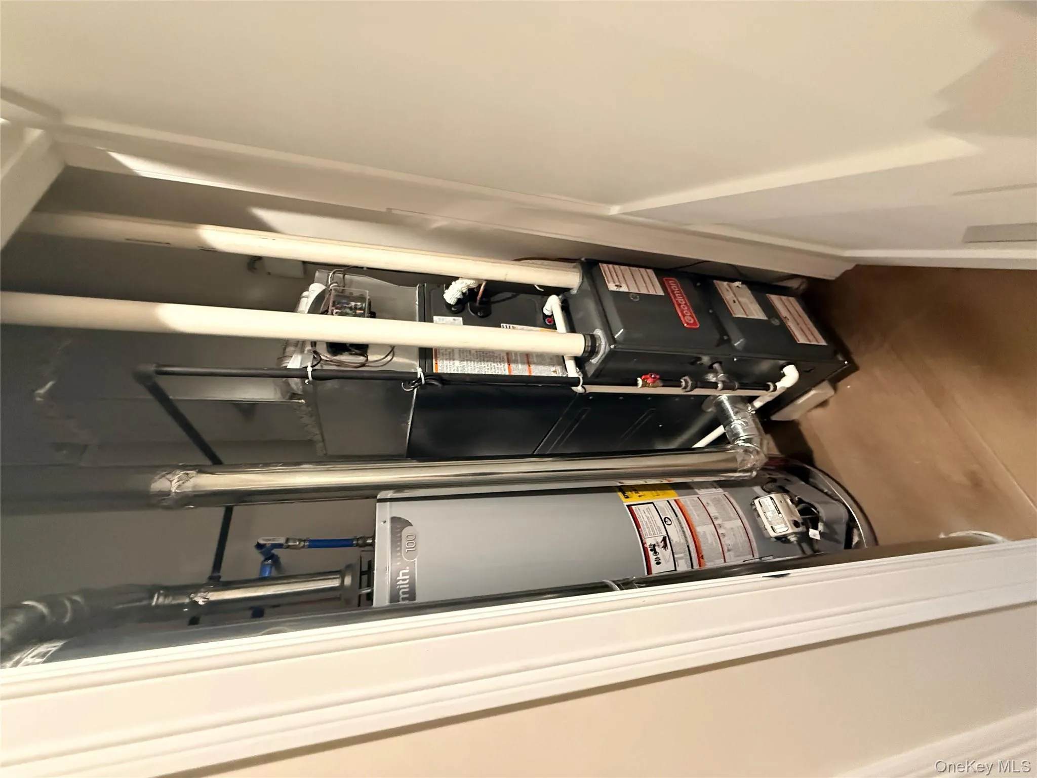 Utility room featuring water heater and heating unit Utility room featuring water heater and heating unit