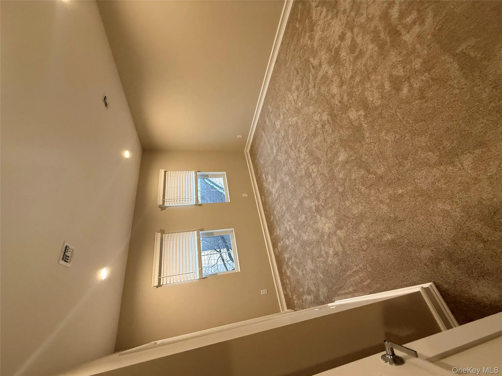 Spare room featuring recessed lighting and dark colored carpet Spare room featuring recessed lighting and dark colored carpet