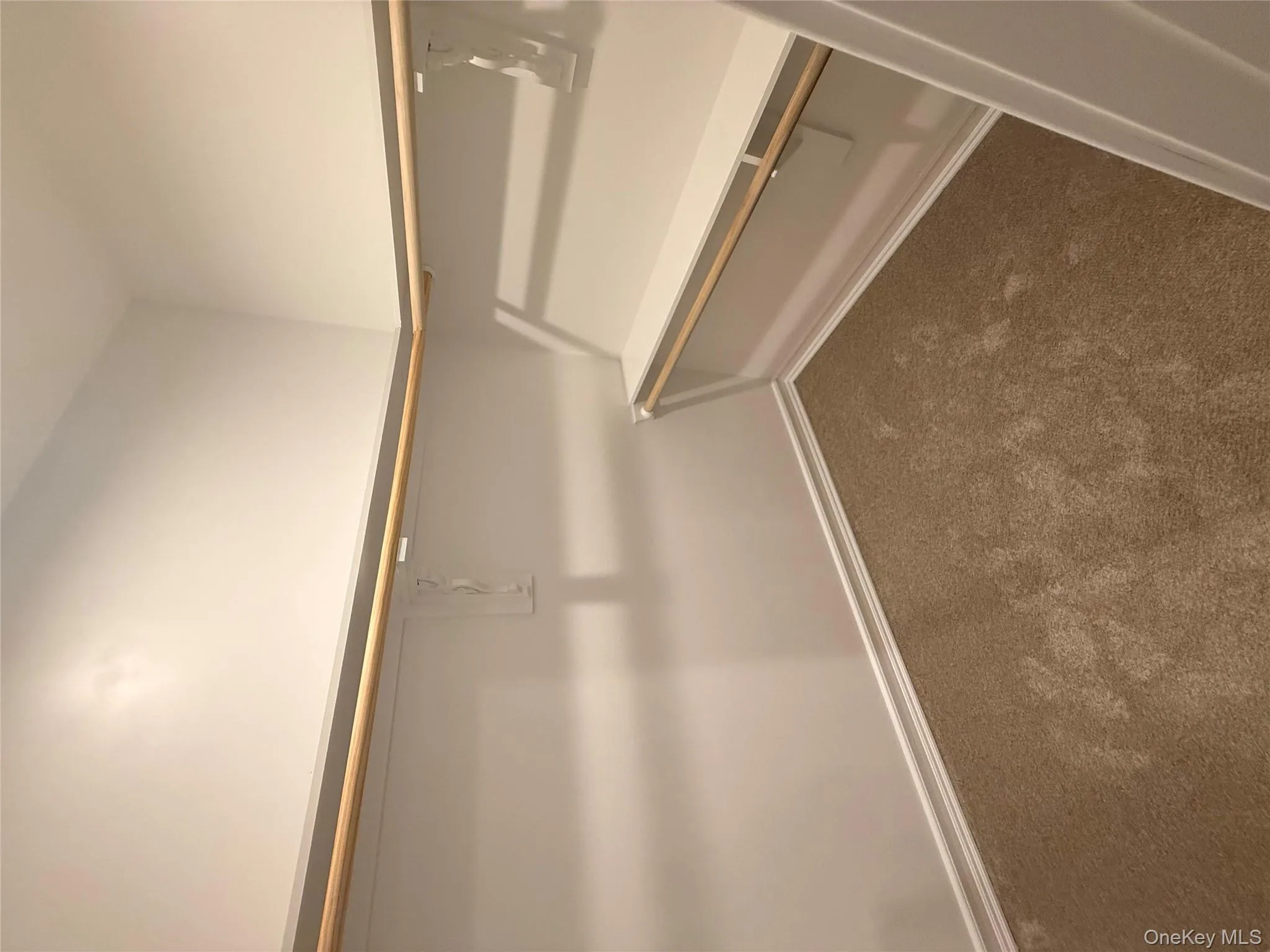 Walk in closet with dark carpet Walk in closet with dark carpet