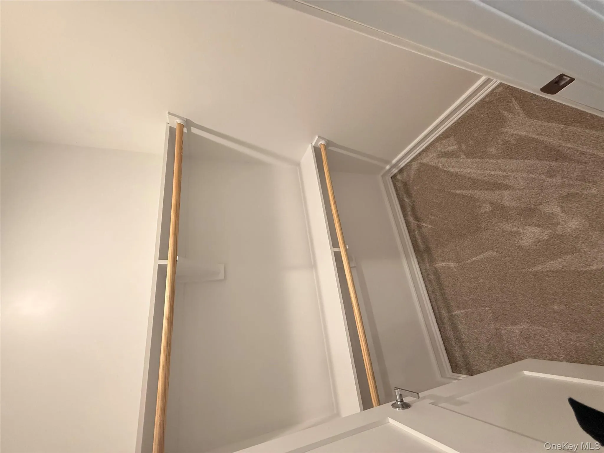 Walk in closet with dark carpet Walk in closet with dark carpet