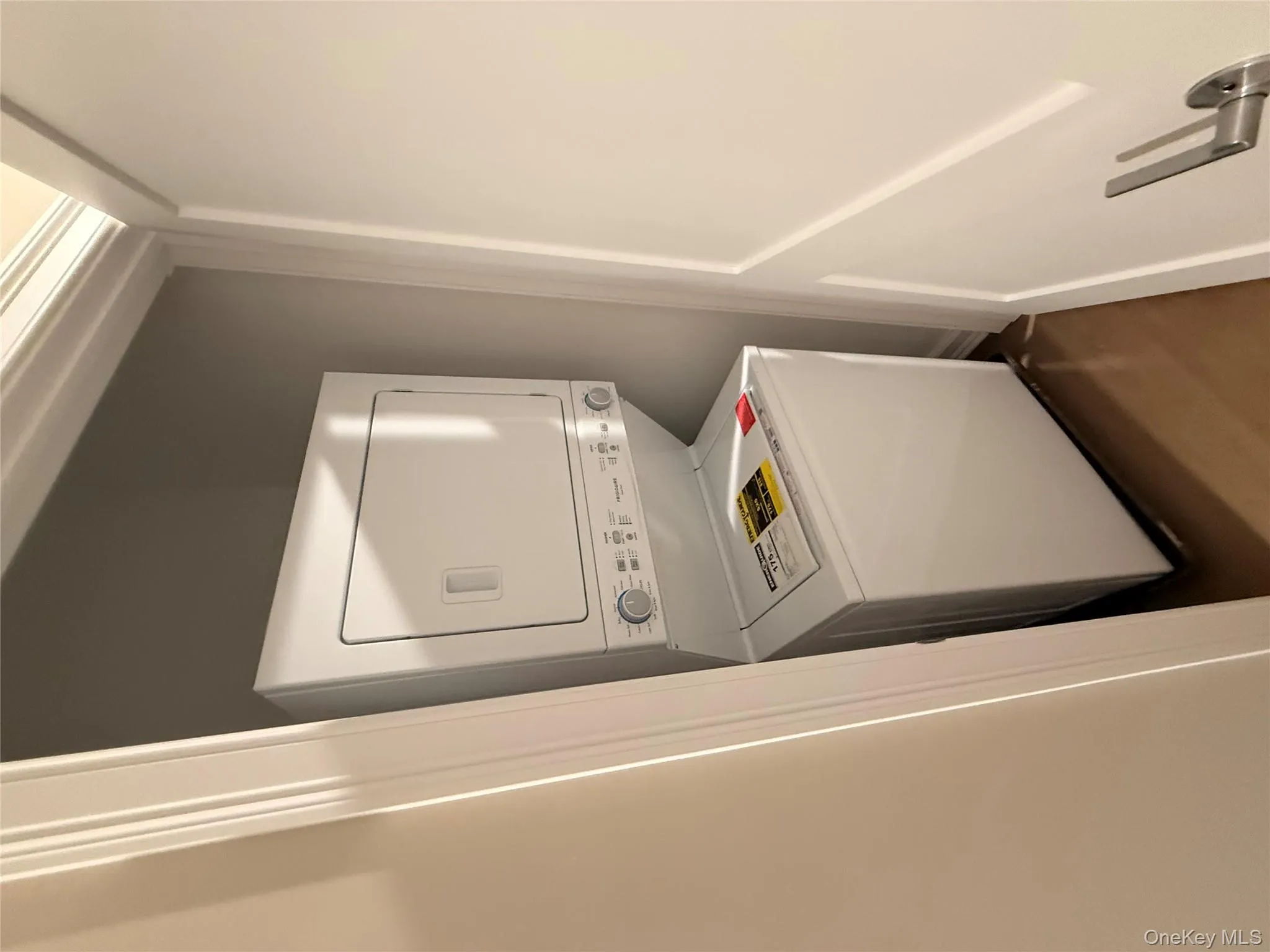 Laundry area with stacked washer and clothes dryer Laundry area with stacked washer and clothes dryer