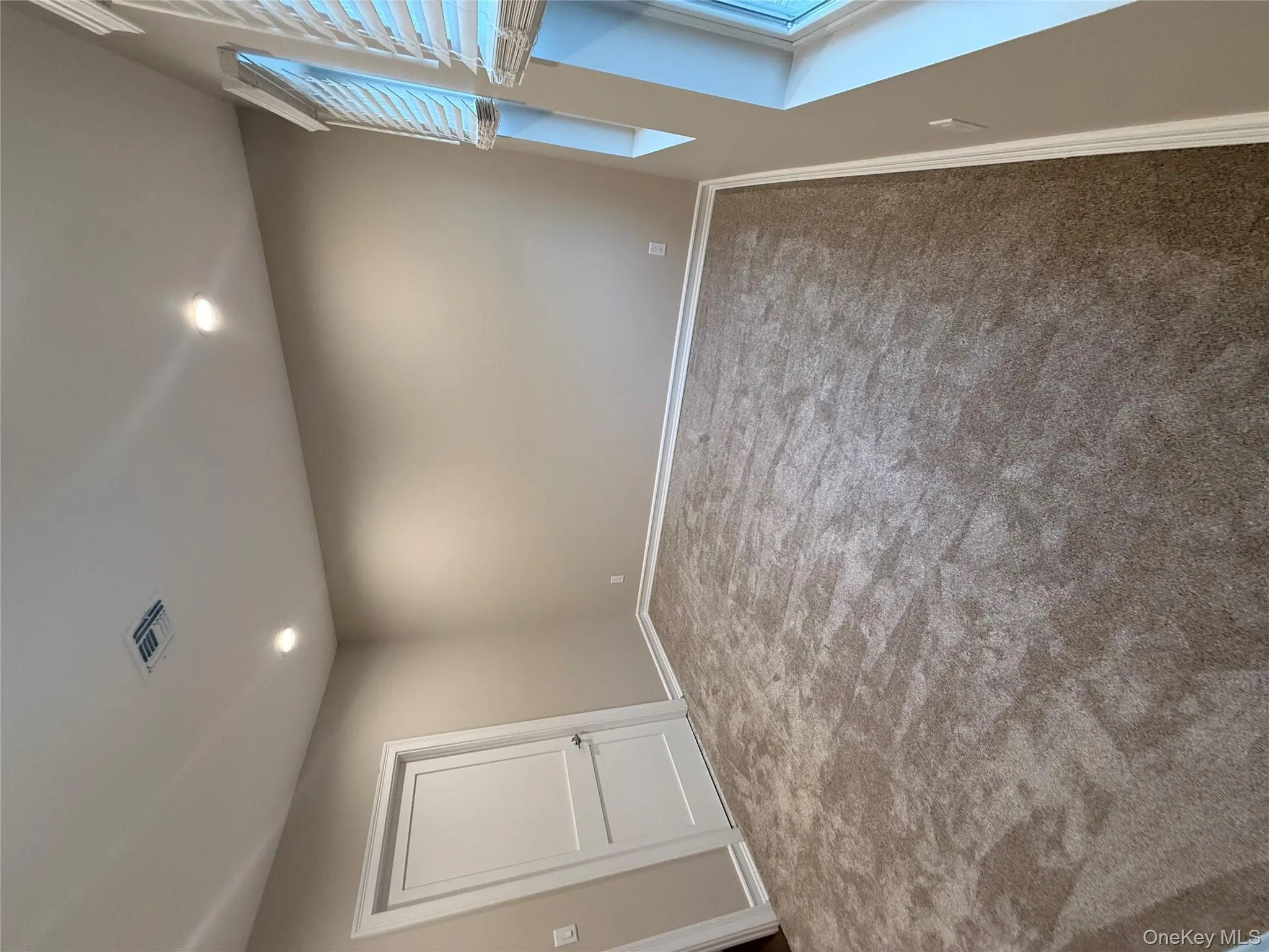 Carpeted empty room featuring recessed lighting and baseboards Carpeted empty room featuring recessed lighting and baseboards