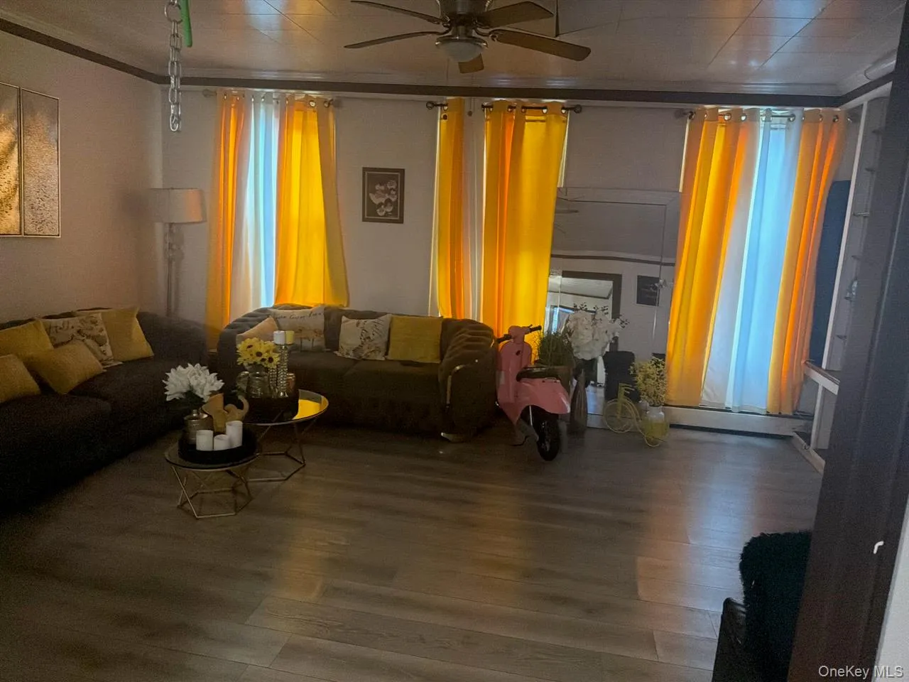 Living area with wood finished floors and a ceiling fan Living area with wood finished floors and a ceiling fan
