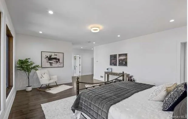 Bedroom with dark wood finished floors and recessed lighting Bedroom with dark wood finished floors and recessed lighting