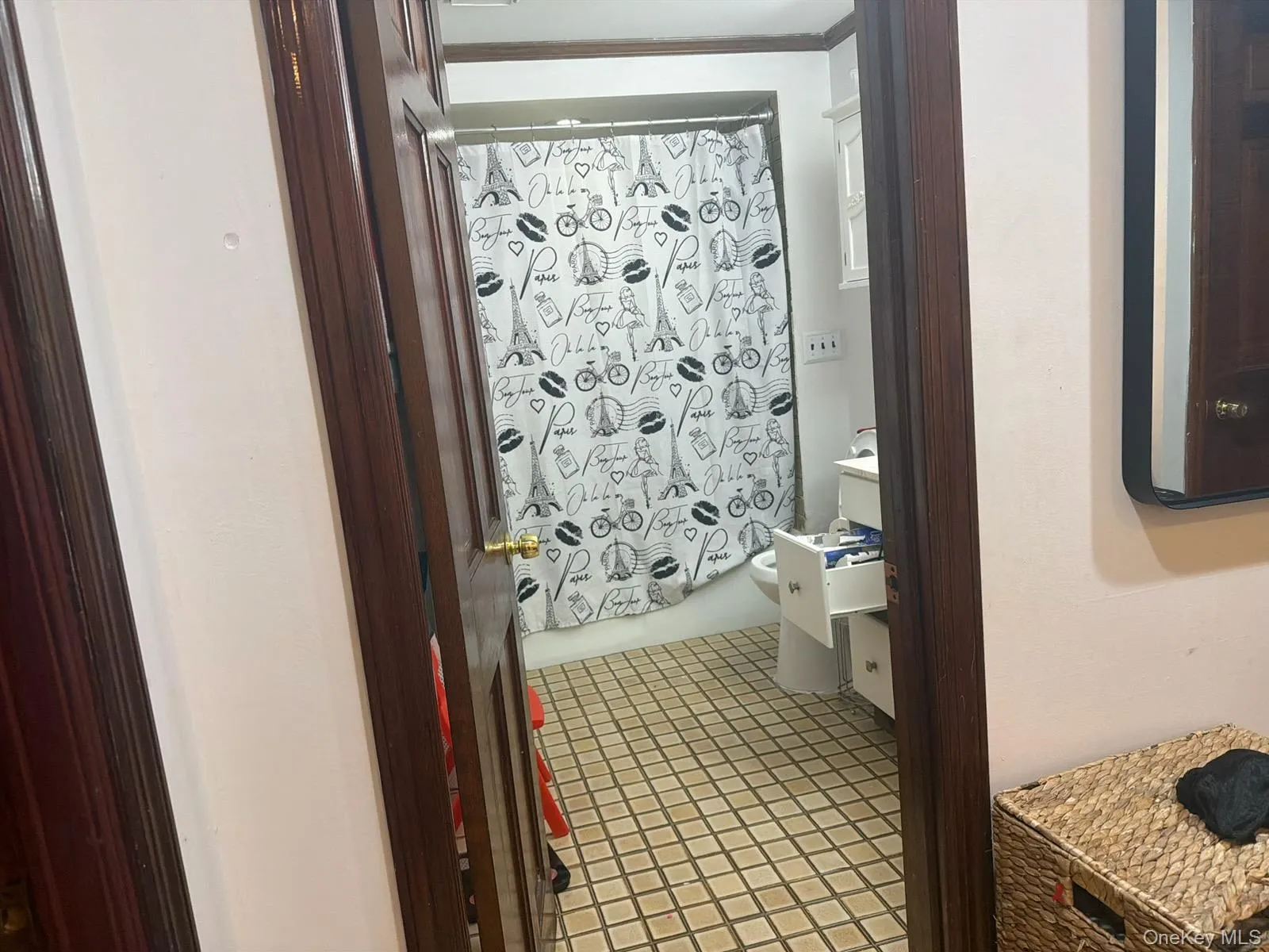 Full bathroom featuring vanity, shower / bath combo, and light tile patterned floors Full bathroom featuring vanity, shower / bath combo, and light tile patterned floors