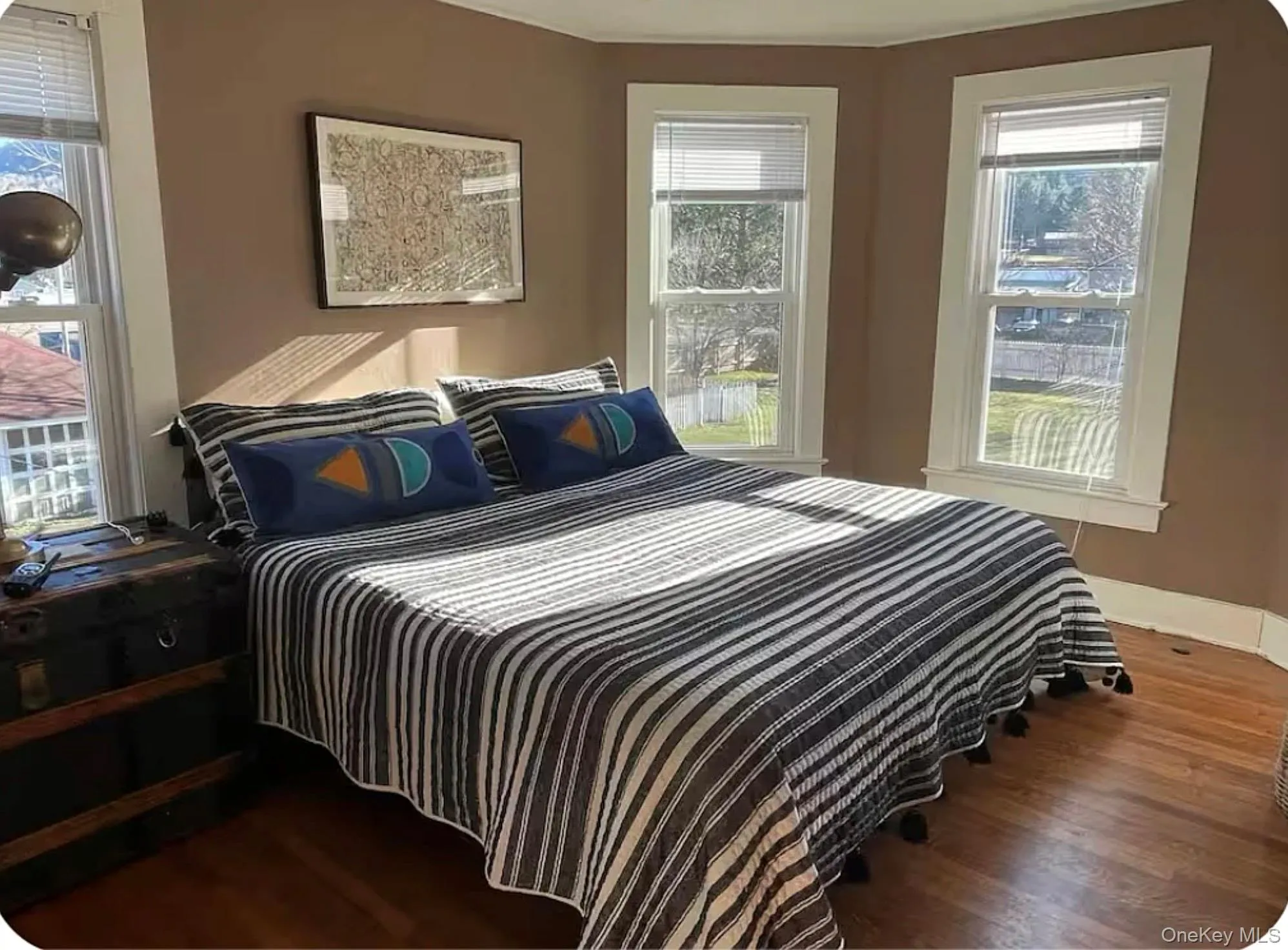 Bedroom with wood finished floors and baseboards Bedroom with wood finished floors and baseboards