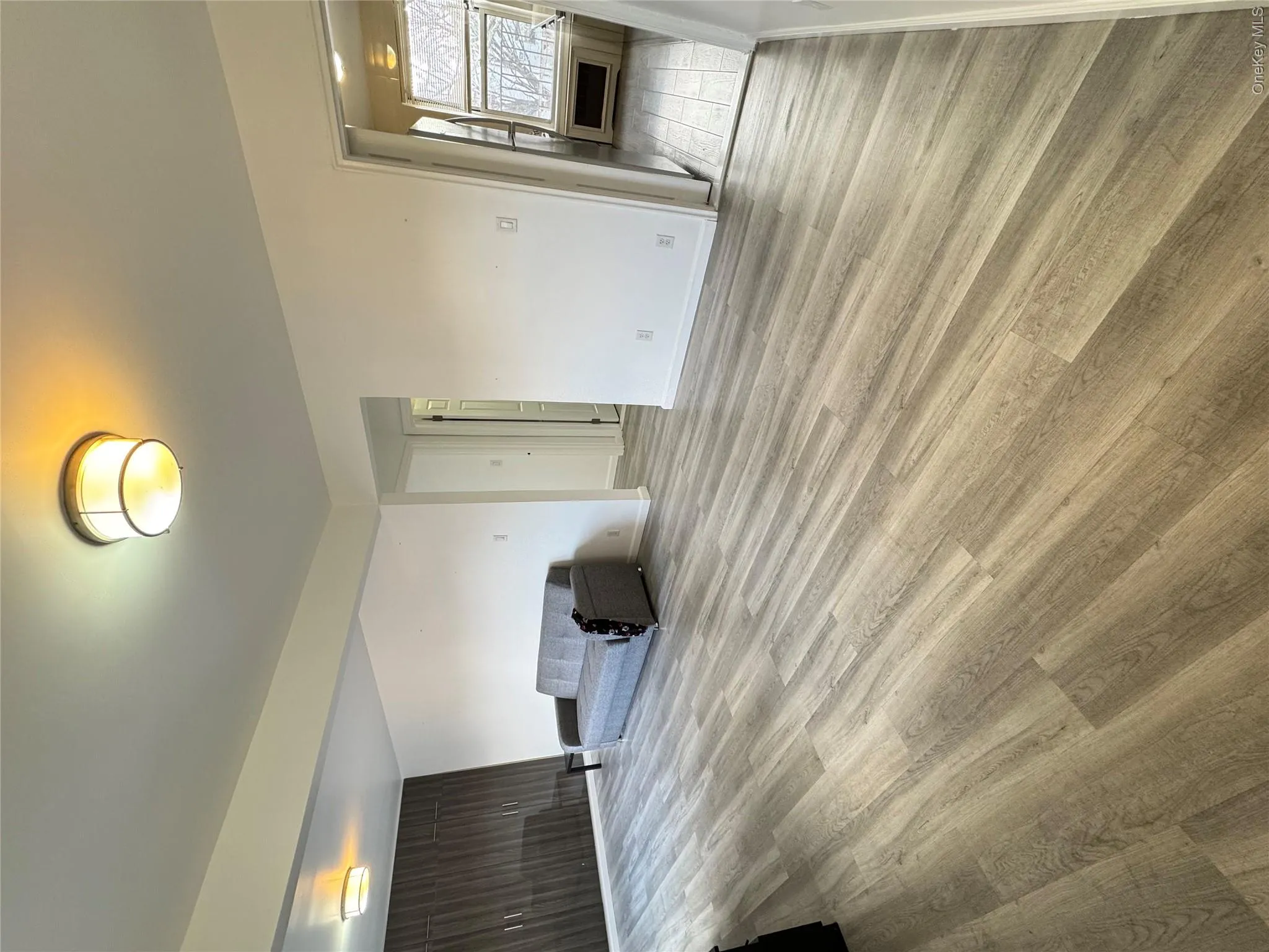 Unfurnished living room with light wood finished floors and baseboards Unfurnished living room with light wood finished floors and baseboards
