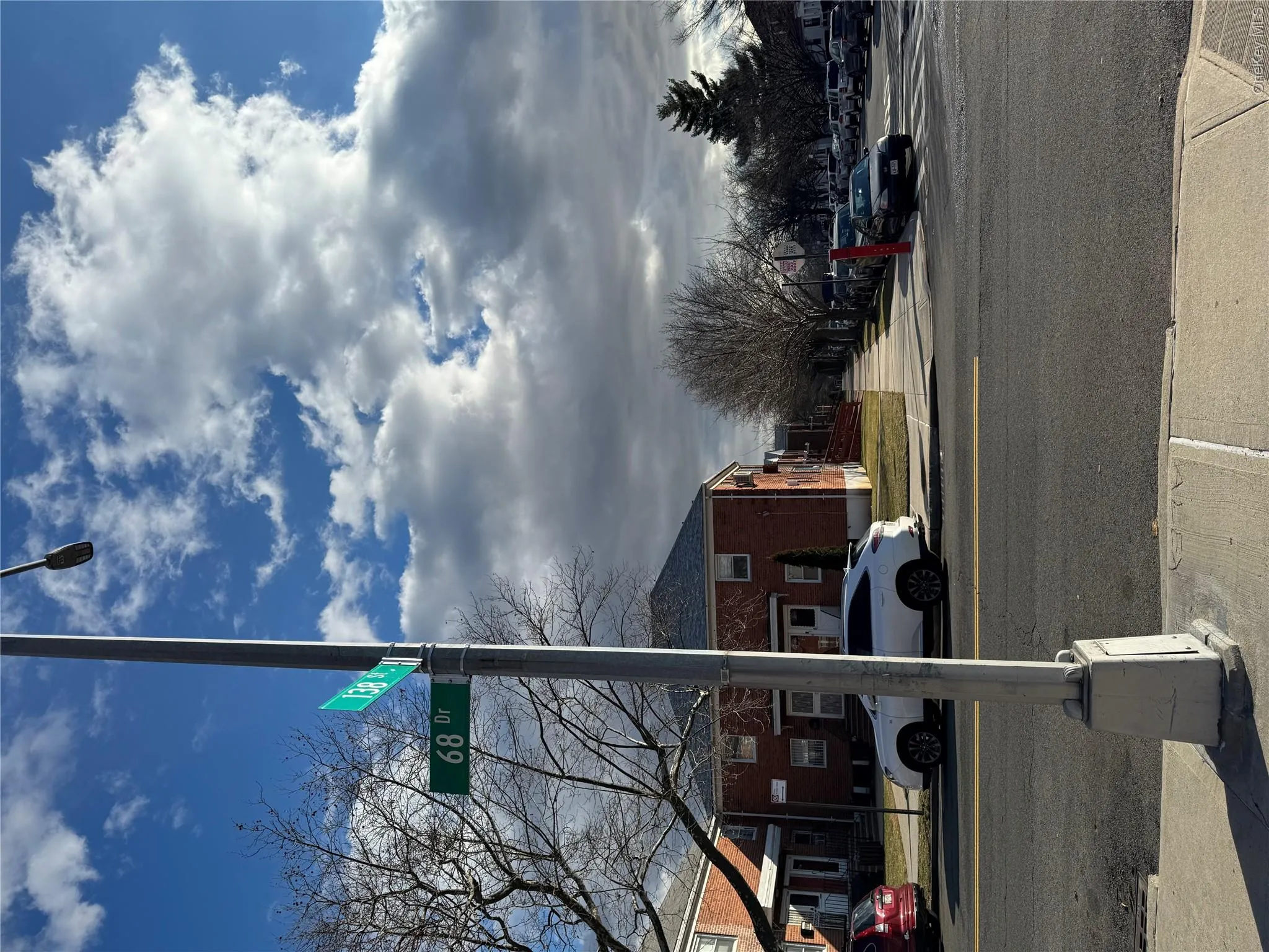 View of asphalt road with sidewalks, curbs, and a residential view View of asphalt road with sidewalks, curbs, and a residential view