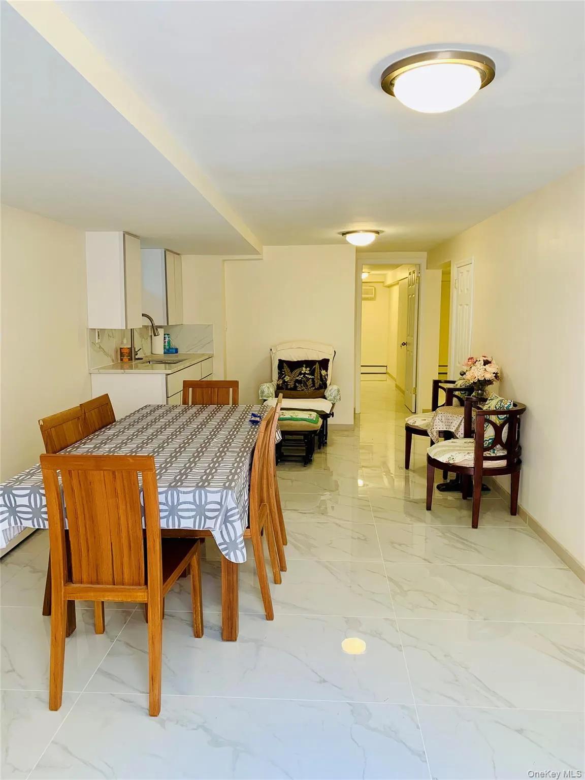 Dining area with light marble finish flooring and baseboards Dining area with light marble finish flooring and baseboards