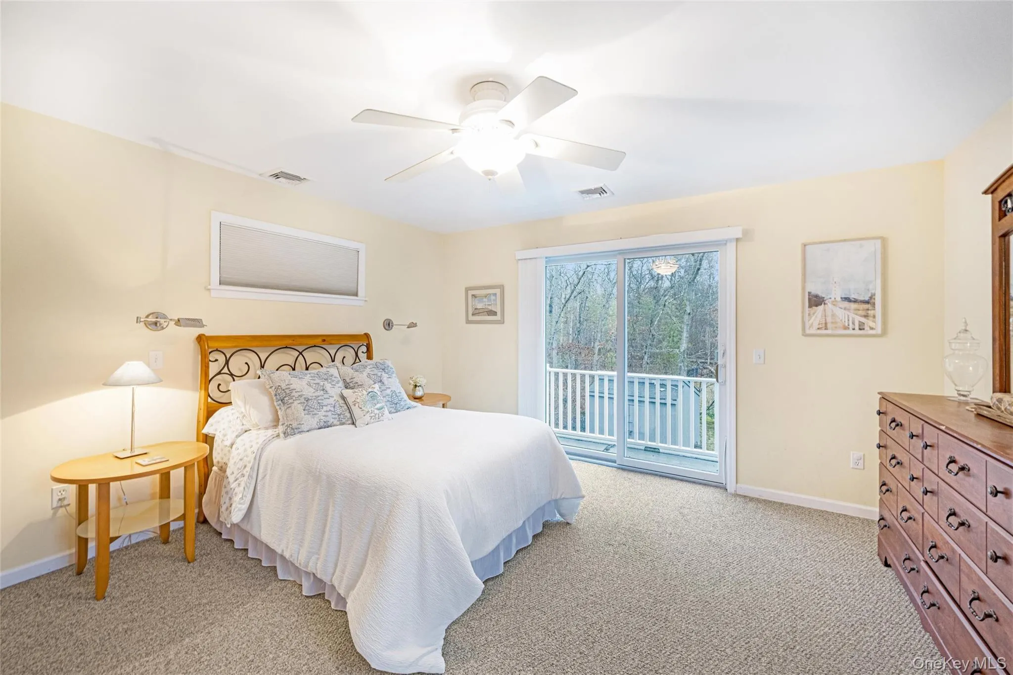 Bedroom 4 featuring light carpet, access to exterior, and ceiling fan Bedroom 4 featuring light carpet, access to exterior, and ceiling fan