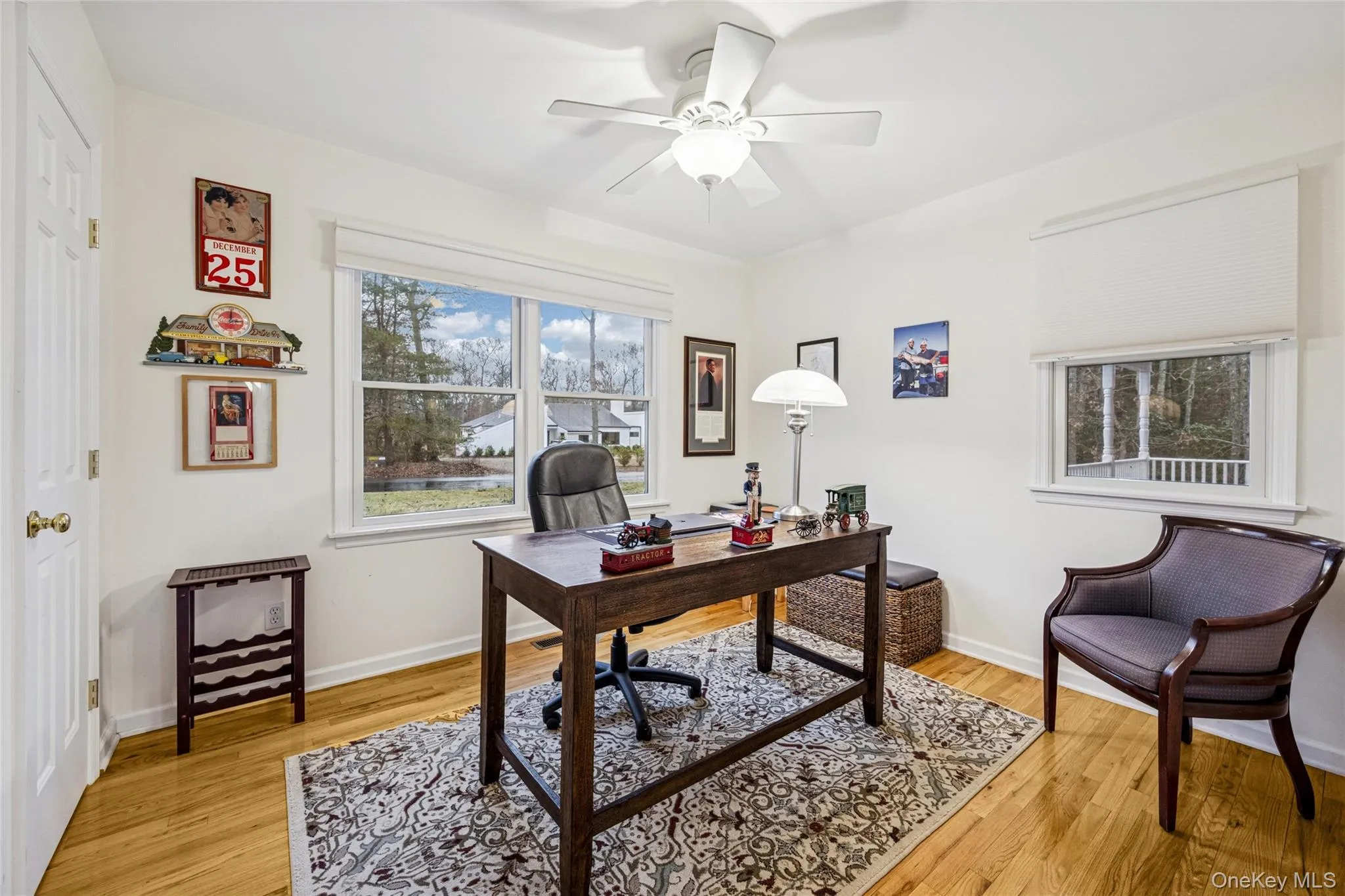 Home office with a ceiling fan and light wood finished floors Home office with a ceiling fan and light wood finished floors