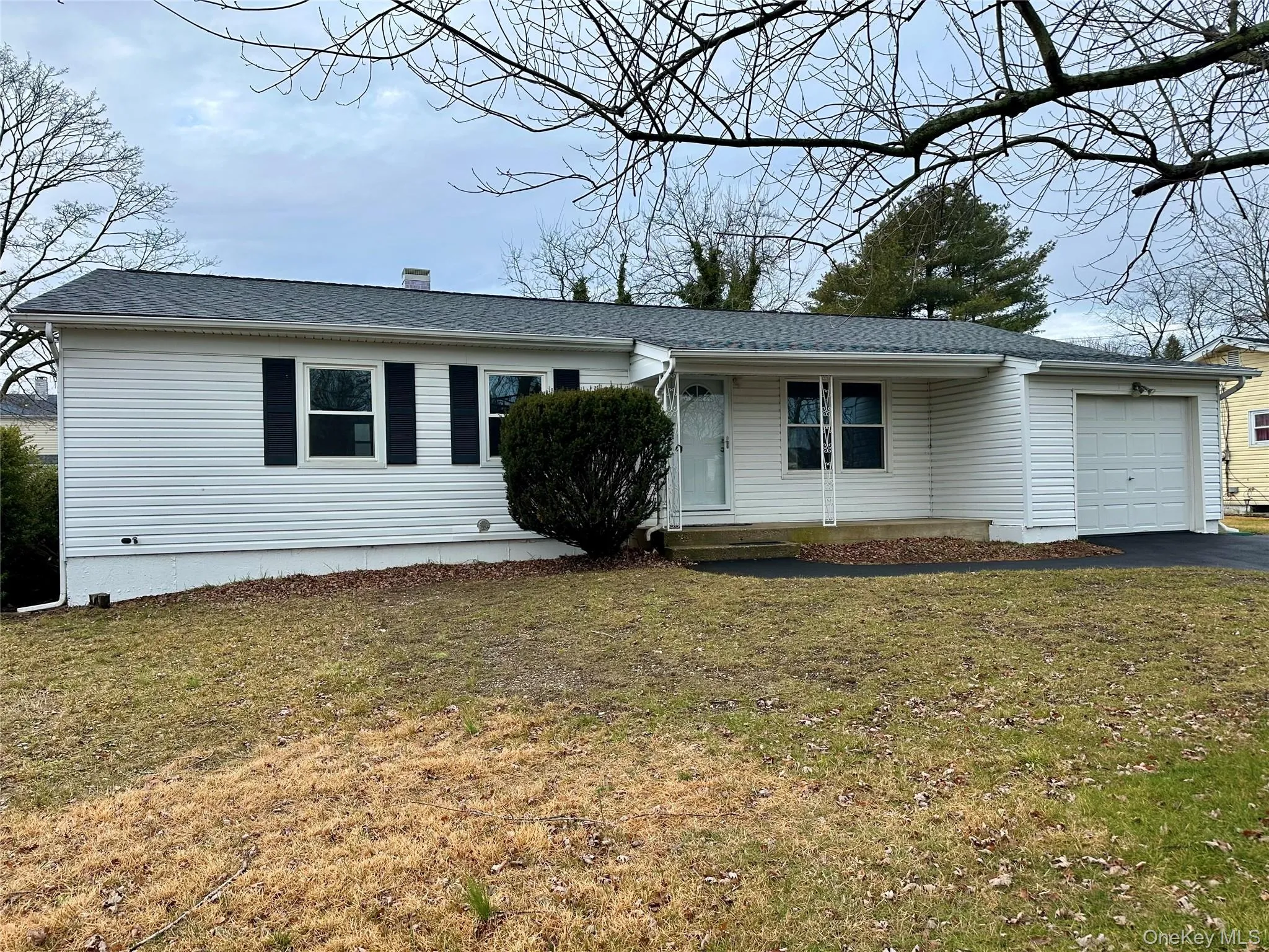 Ranch-style home featuring a front yard, driveway, a garage, and a shingled roof Ranch-style home featuring a front yard, driveway, a garage, and a shingled roof