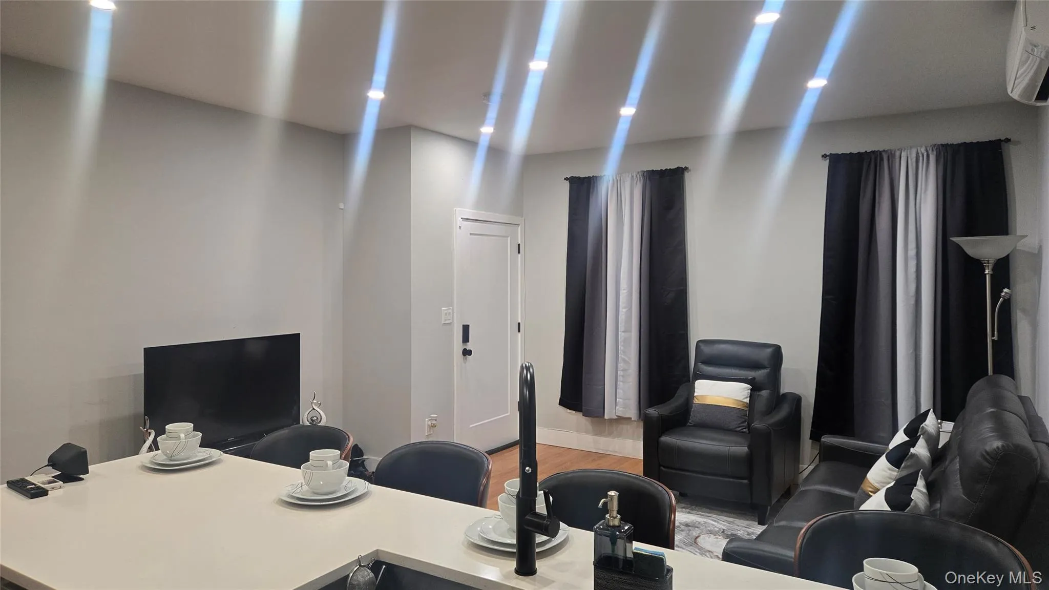 Office featuring light wood-style floors and a wall unit AC Office featuring light wood-style floors and a wall unit AC