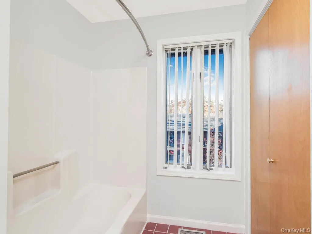 Full bath with shower combination and tile patterned flooring Full bath with shower combination and tile patterned flooring