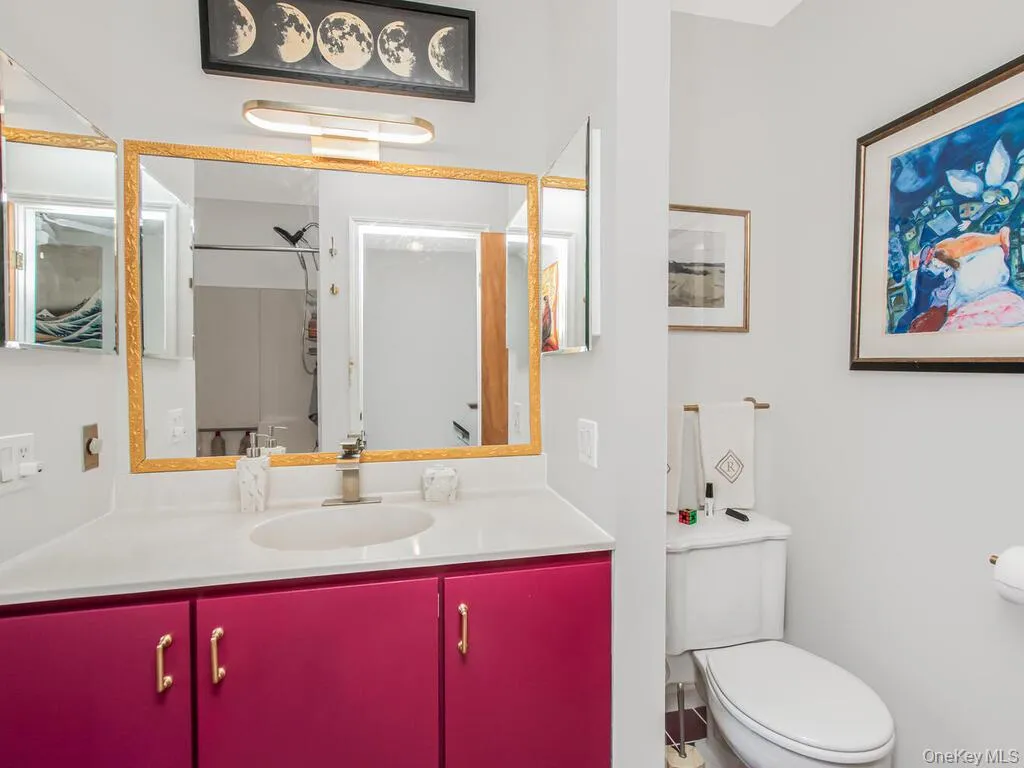 Bathroom featuring vanity and a shower Bathroom featuring vanity and a shower