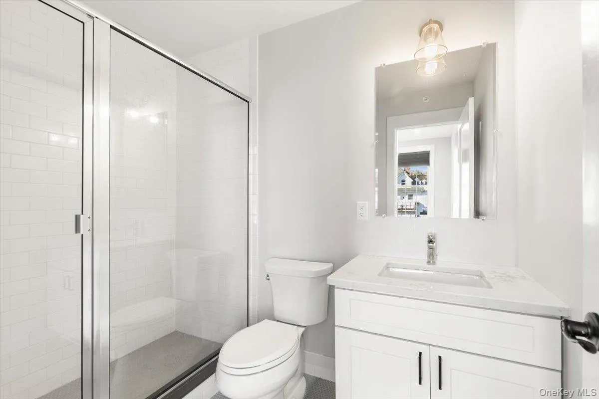 Full bath featuring vanity and a shower stall Full bath featuring vanity and a shower stall