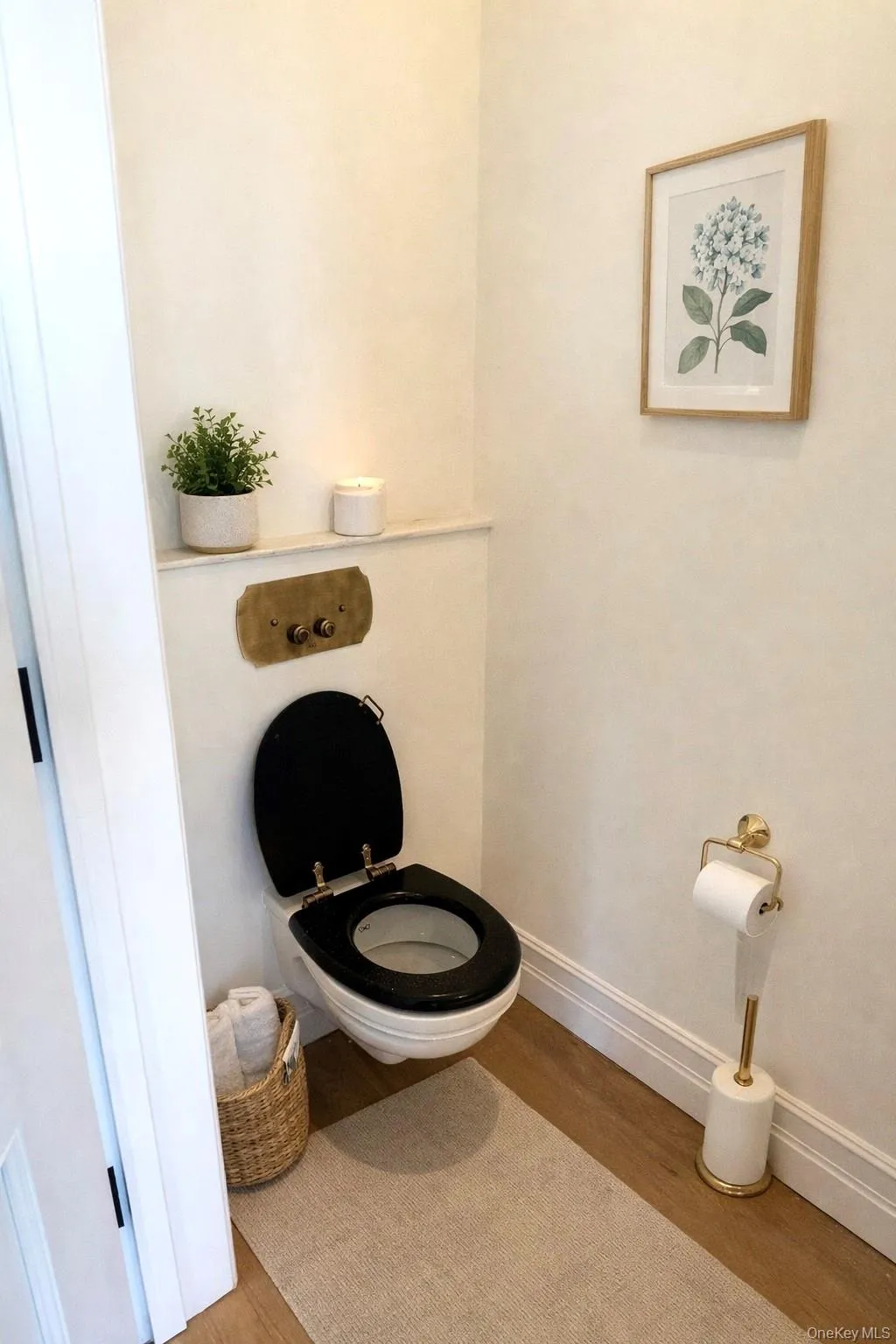 Half Bathroom featuring toilet and wood finished floors Half Bathroom featuring toilet and wood finished floors