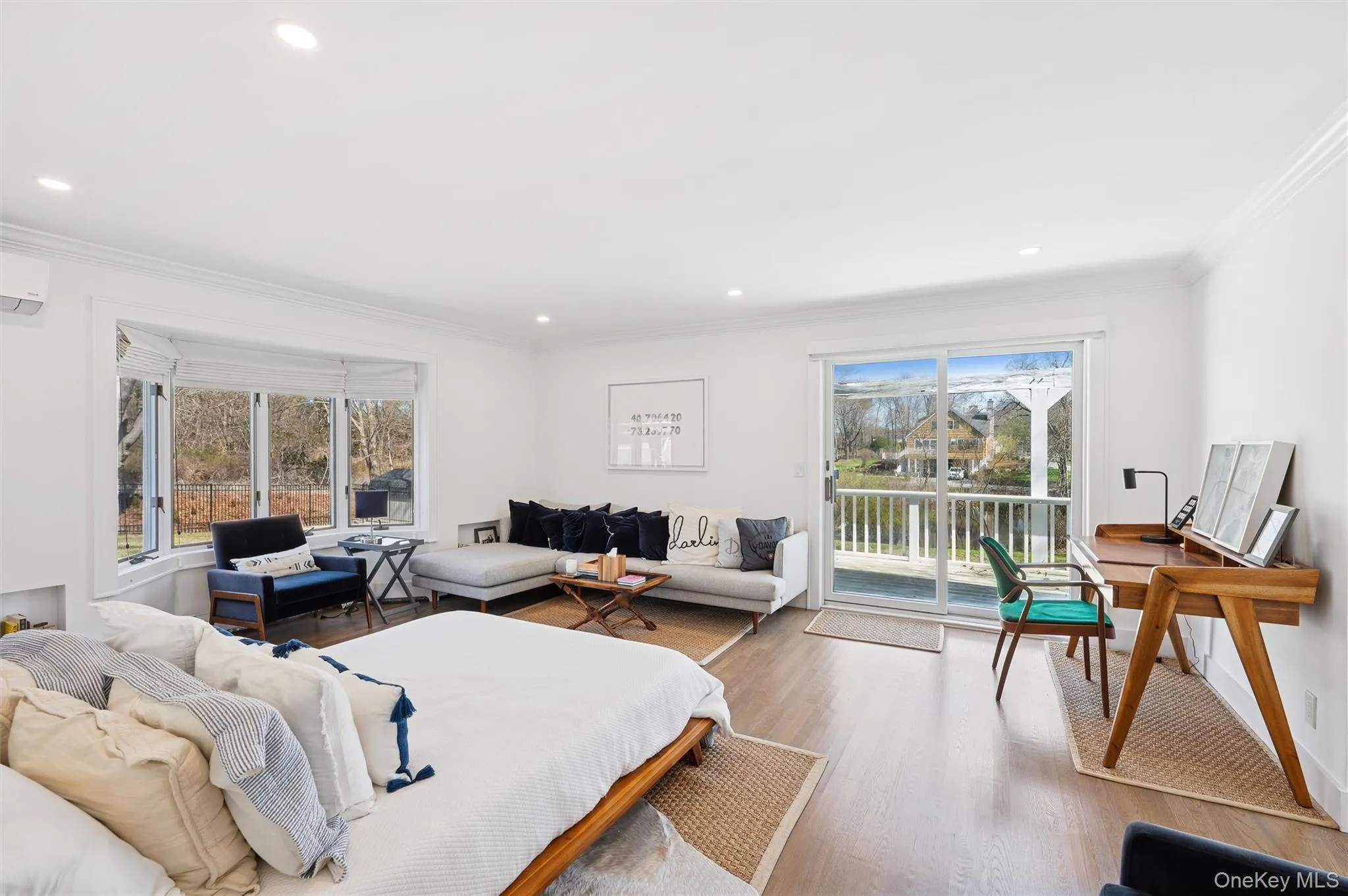 Bedroom with recessed lighting, crown molding, access to exterior, a wall unit AC, and wood finished floors Bedroom with recessed lighting, crown molding, access to exterior, a wall unit AC, and wood finished floors