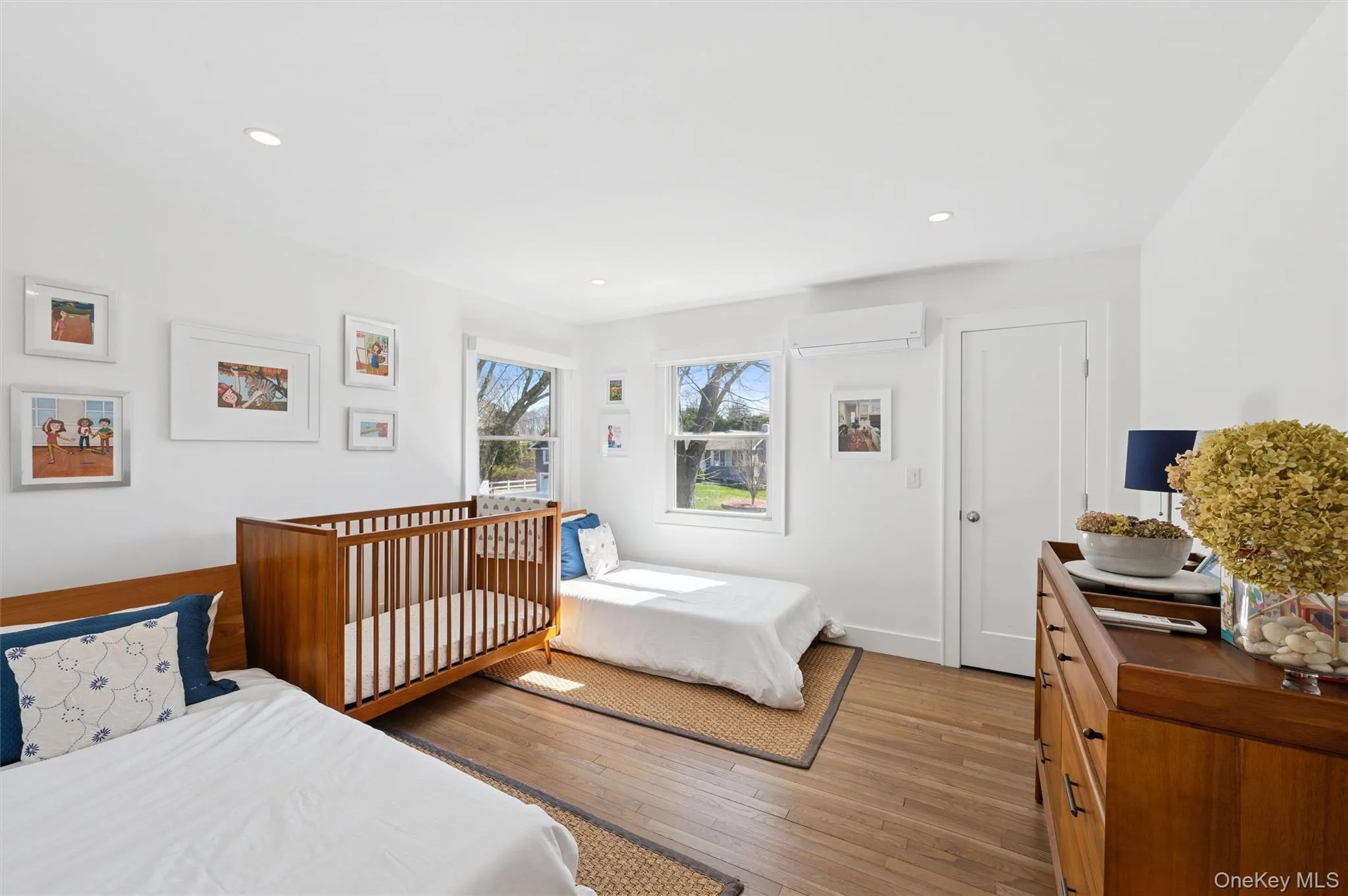 Bedroom featuring an AC wall unit, recessed lighting, and hardwood / wood-style floors Bedroom featuring an AC wall unit, recessed lighting, and hardwood / wood-style floors