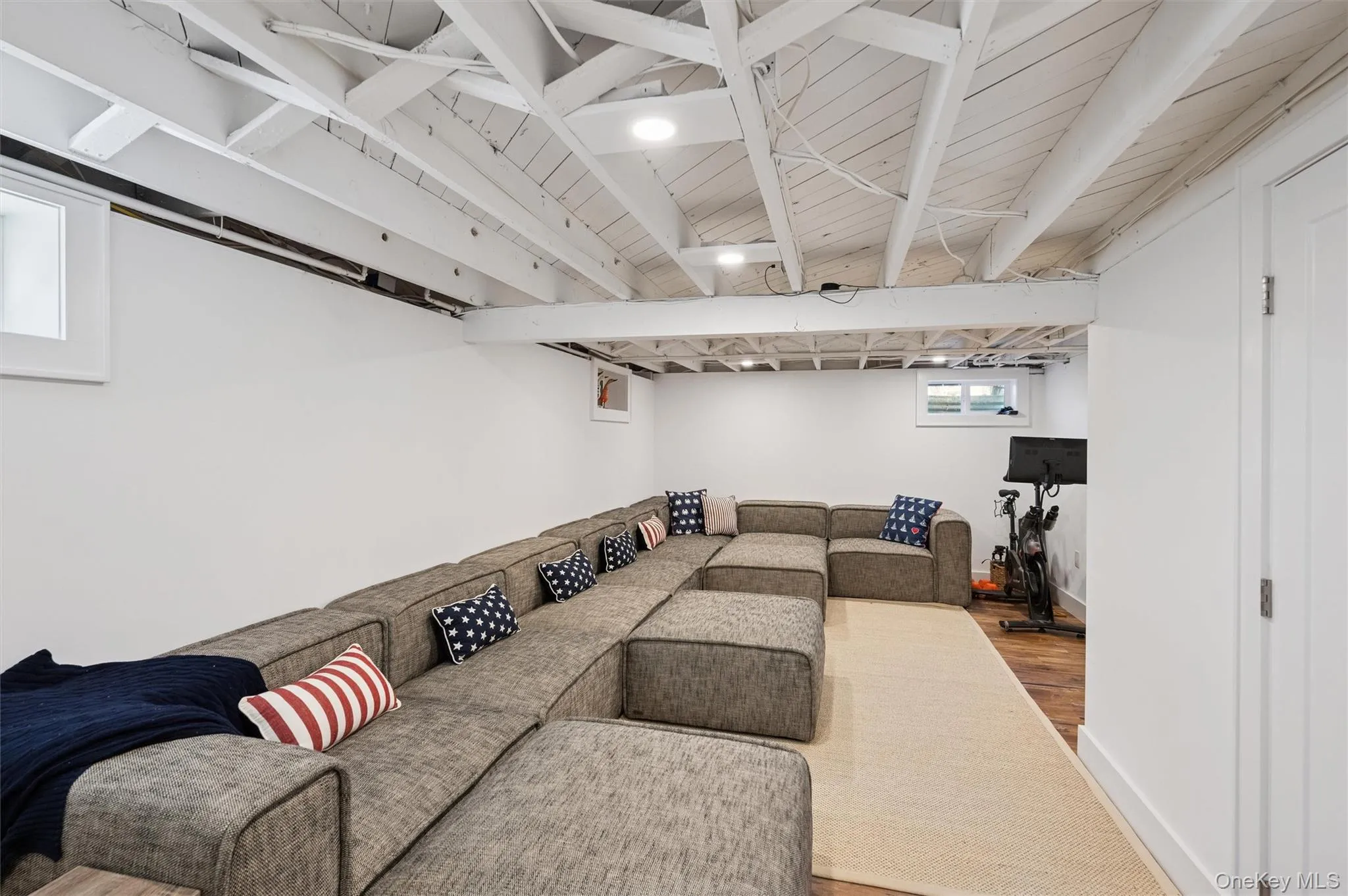 Living room featuring baseboards and wood finished floors Living room featuring baseboards and wood finished floors