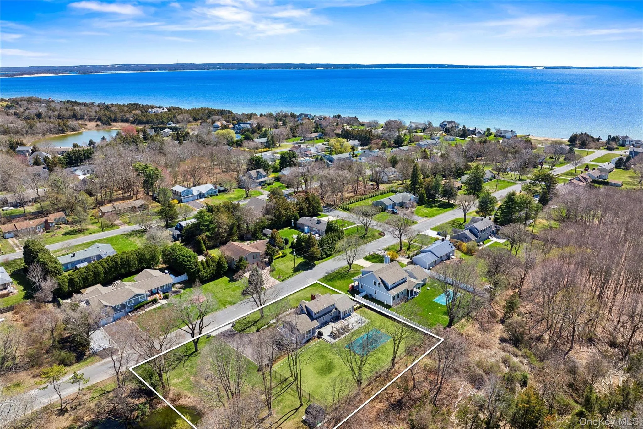 Birds eye view of property with a water view and a residential view Birds eye view of property with a water view and a residential view