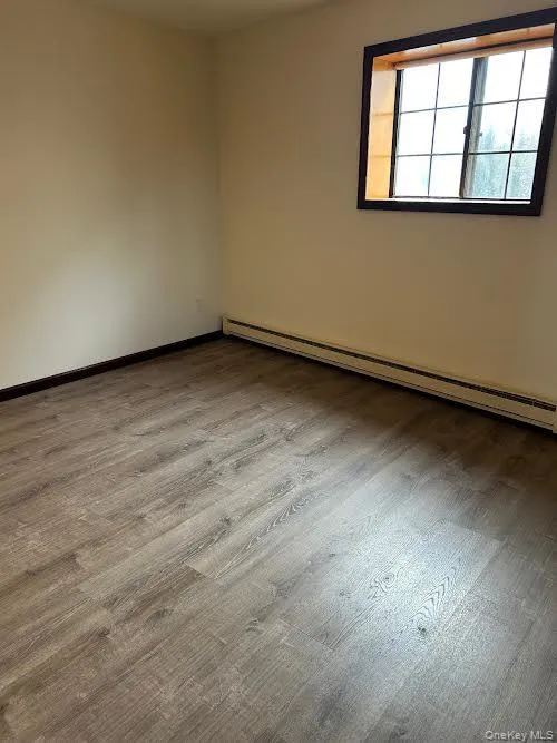 dining area with baseboard heating and light wood-style floors dining area with baseboard heating and light wood-style floors