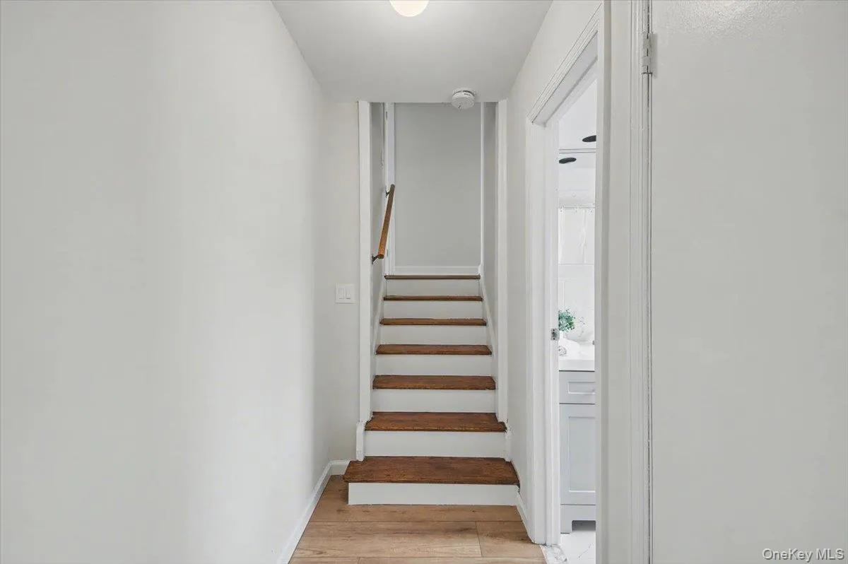 Staircase with wood finished floors and baseboards Staircase with wood finished floors and baseboards