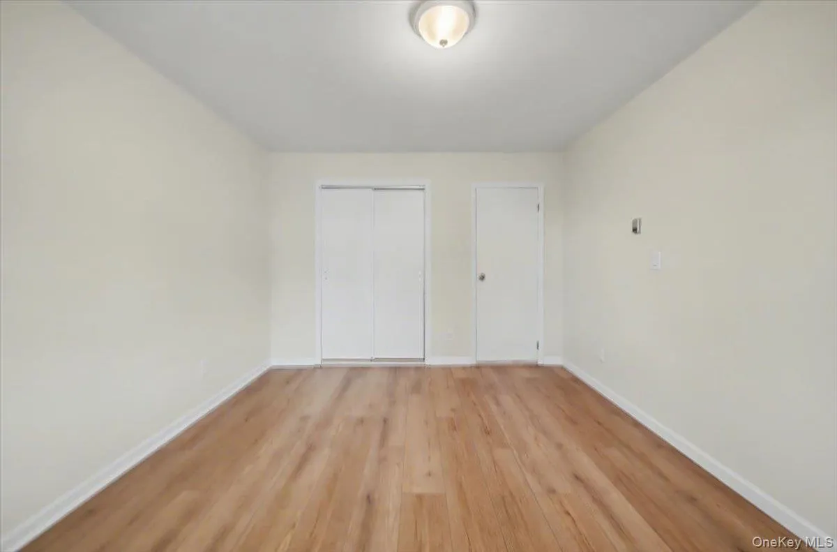 Unfurnished bedroom with light wood-style flooring and a closet Unfurnished bedroom with light wood-style flooring and a closet